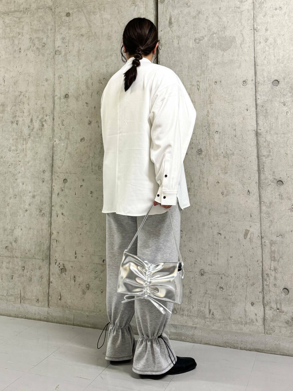 ブラック系のその他シューズ、グレー系のその他パンツ、ホワイト系のシャツ/ブラウスを着用したレディースの冬コーディネートの3枚目の写真