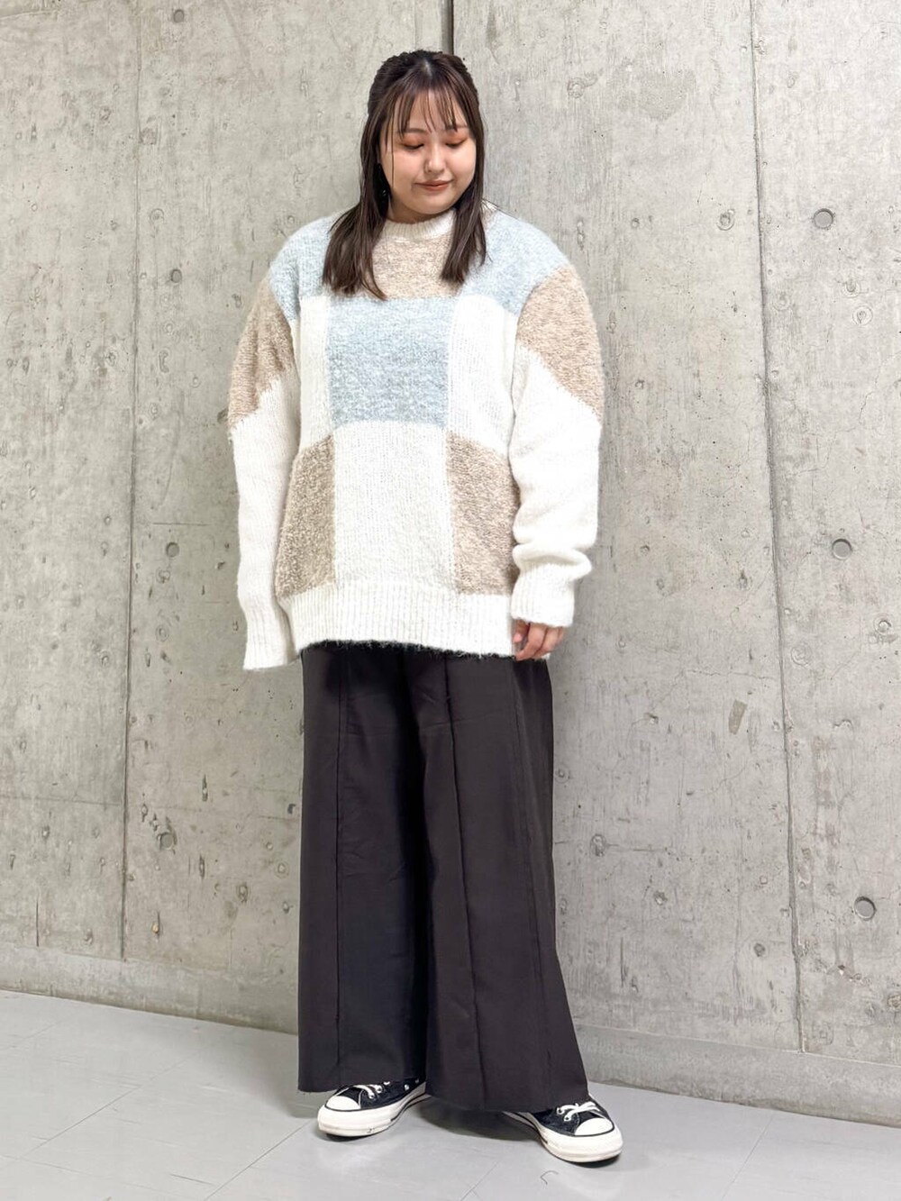 ホワイト系のニット/セーター、ブラウン系のその他パンツ、ベージュ系のステンカラーコートを着用したレディースの冬コーディネートの2枚目の写真