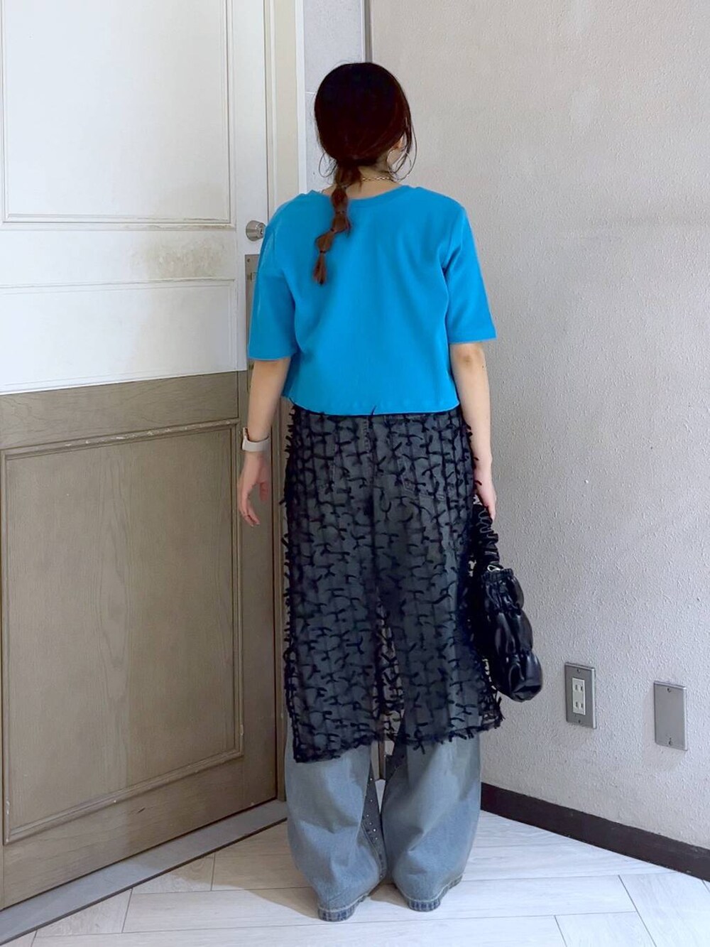 ブラック系のサンダル、ブルー系のデニムパンツ、ブラック系のショルダーバッグを着用したレディースの夏コーディネートの5枚目の写真