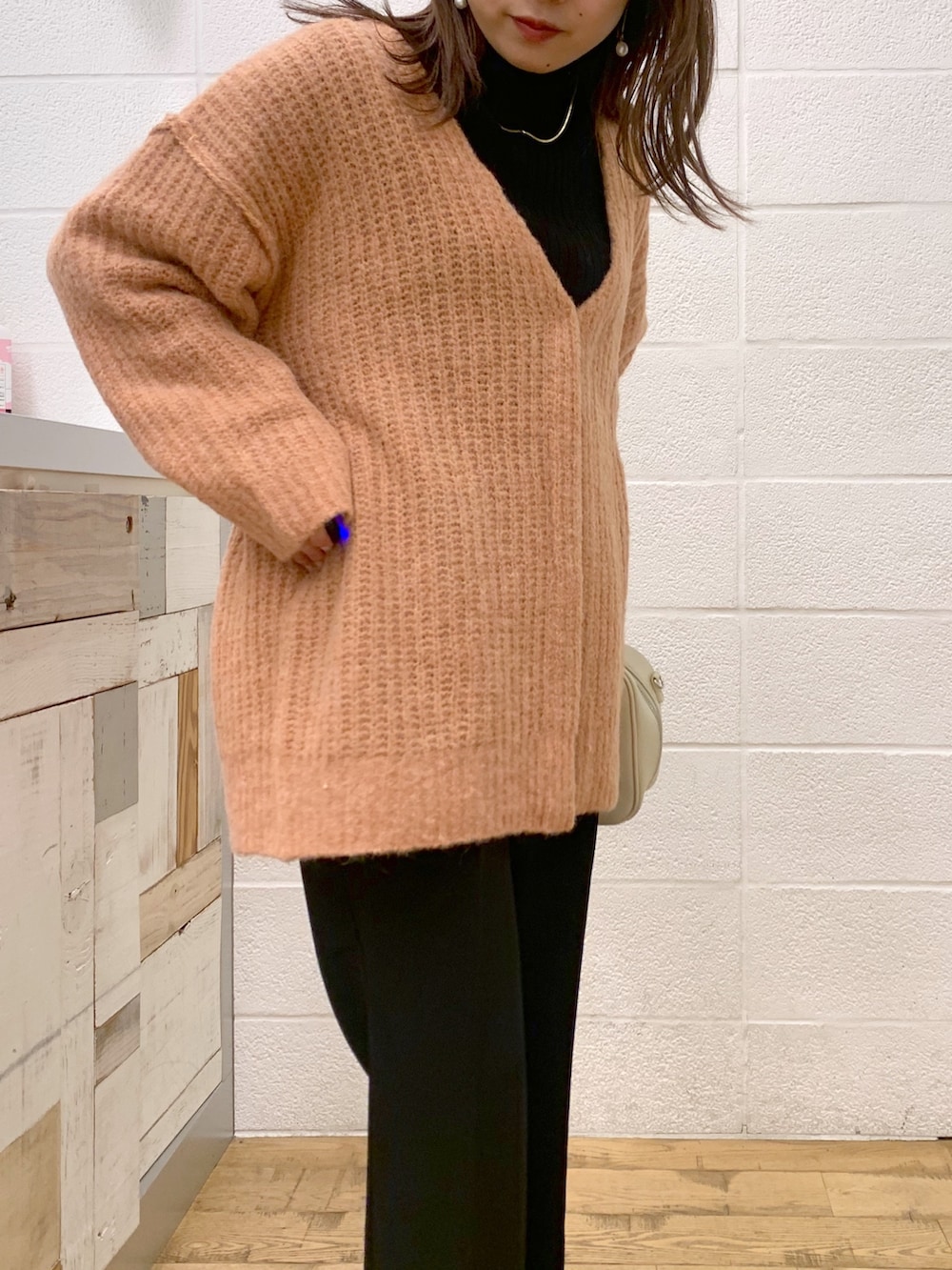 ピンク系のトップス、ブラック系のトップス、ブラック系のスラックスを着用したレディースの秋コーディネートの4枚目の写真