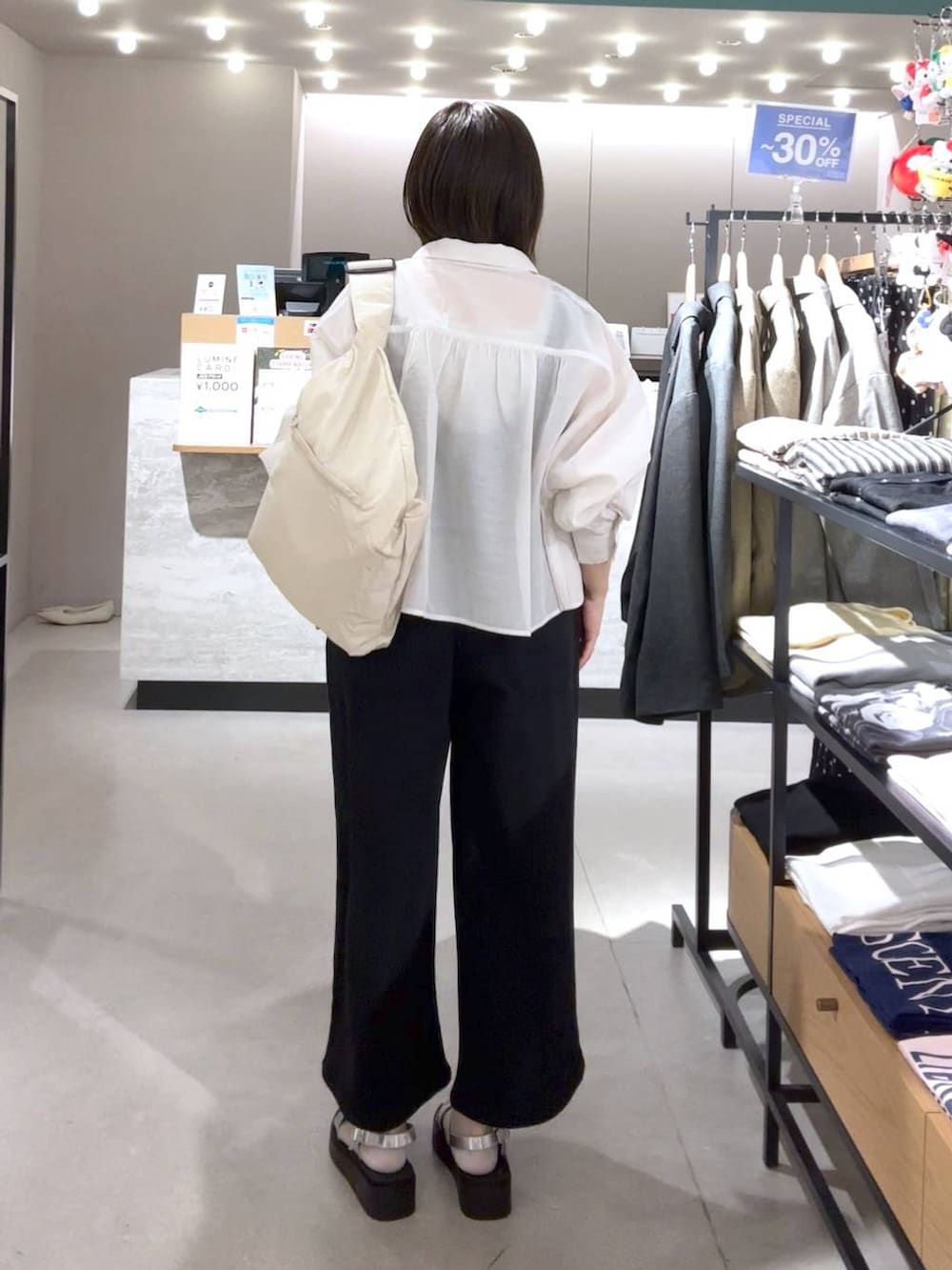 ホワイト系のシャツ/ブラウス、シルバー系のサンダル、ホワイト系のショルダーバッグを着用したレディースの春コーディネートの2枚目の写真