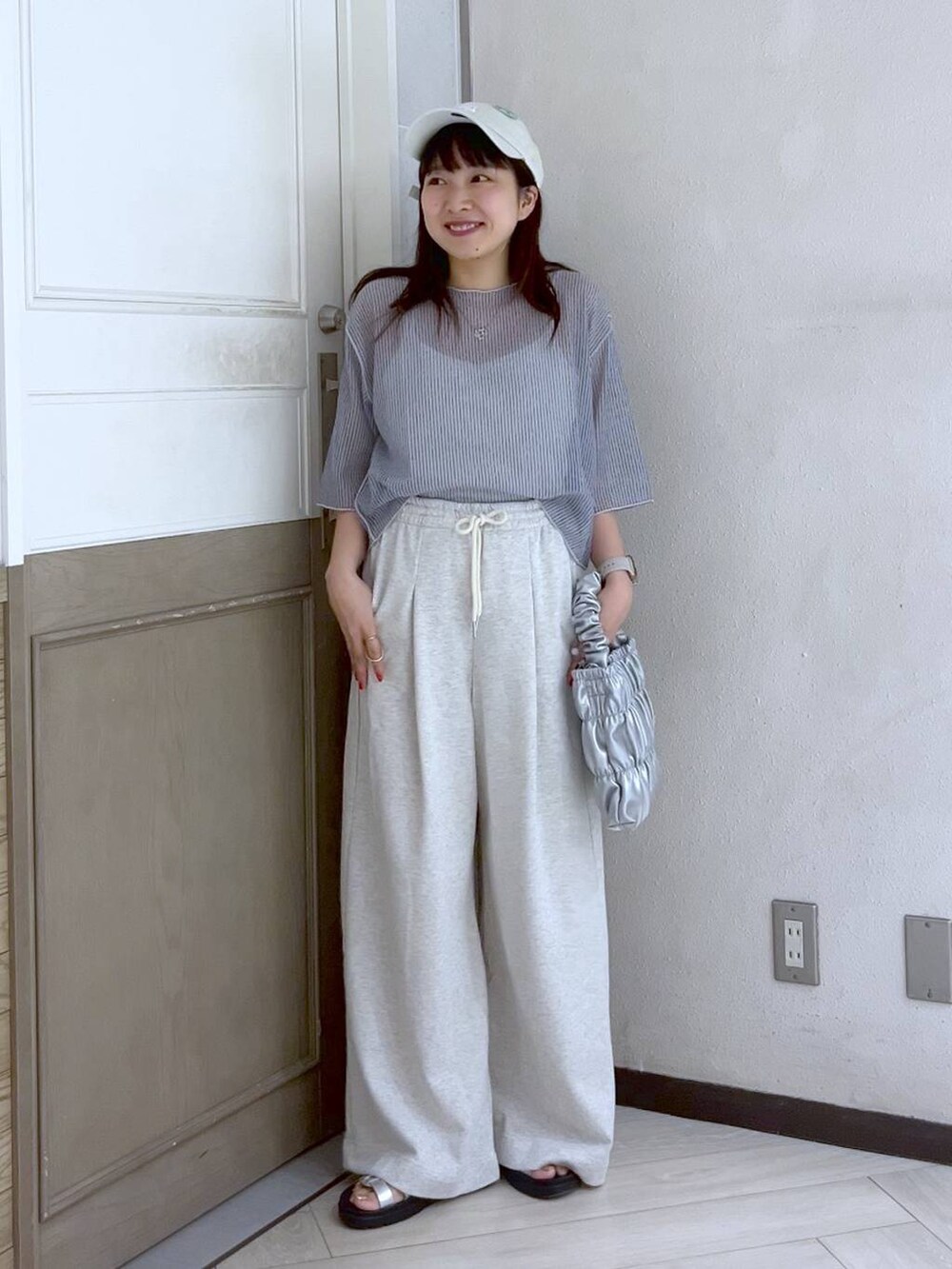 グレー系のスウェットパンツ、シルバー系のスニーカー、グレー系のTシャツ/カットソーを着用したレディースの夏コーディネートの3枚目の写真