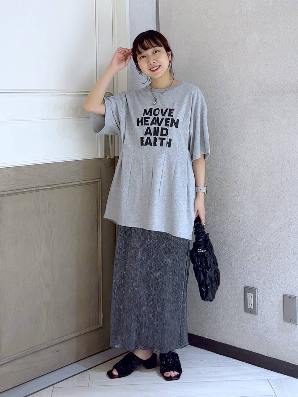 ブラック系のサンダル、ブラック系のショルダーバッグ、グレー系のTシャツ/カットソーを着用したレディースの夏コーディネートの2枚目の写真