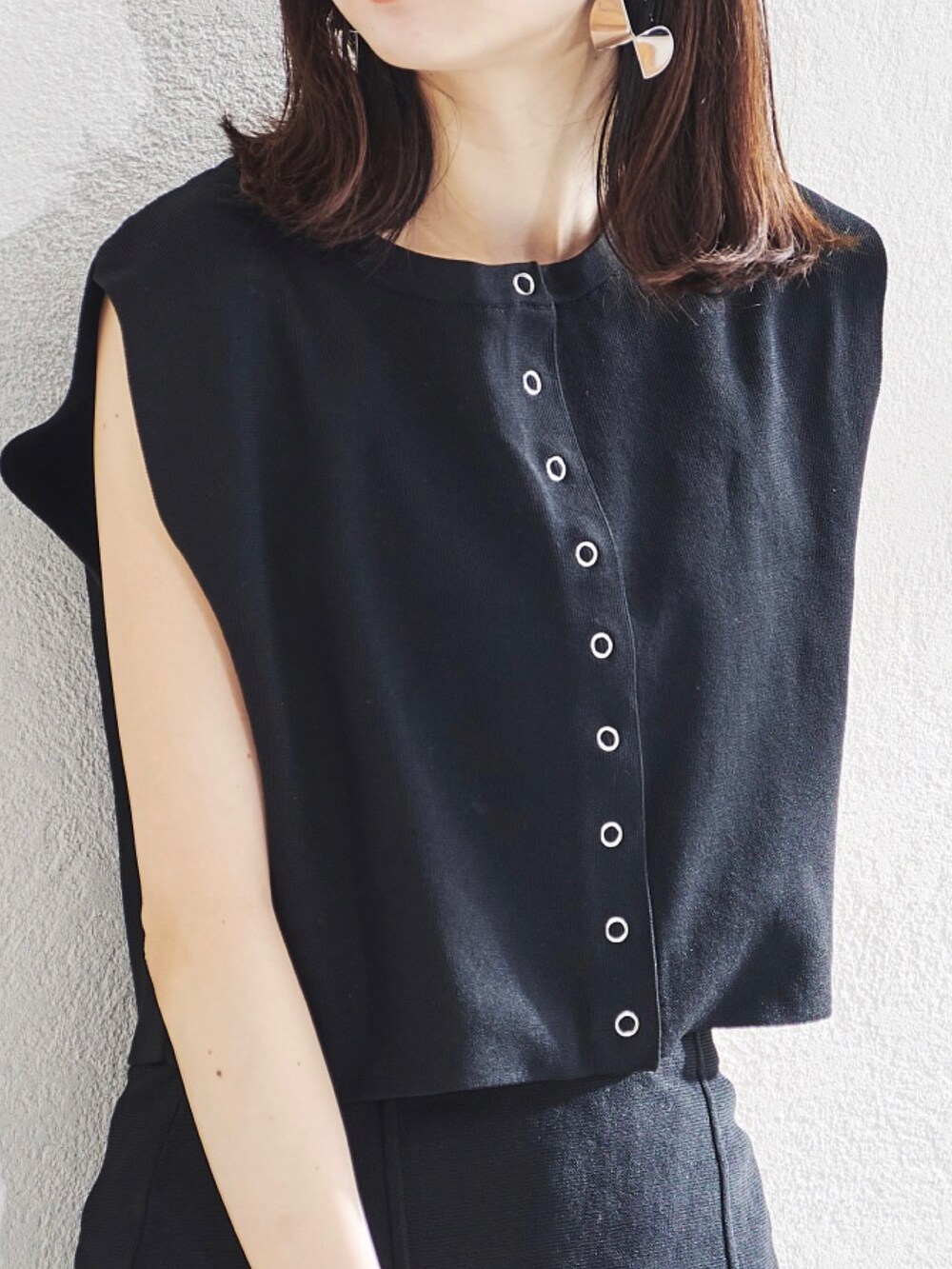 ブラック系のベスト、ブラック系のスカートを着用したレディースの夏コーディネートの4枚目の写真