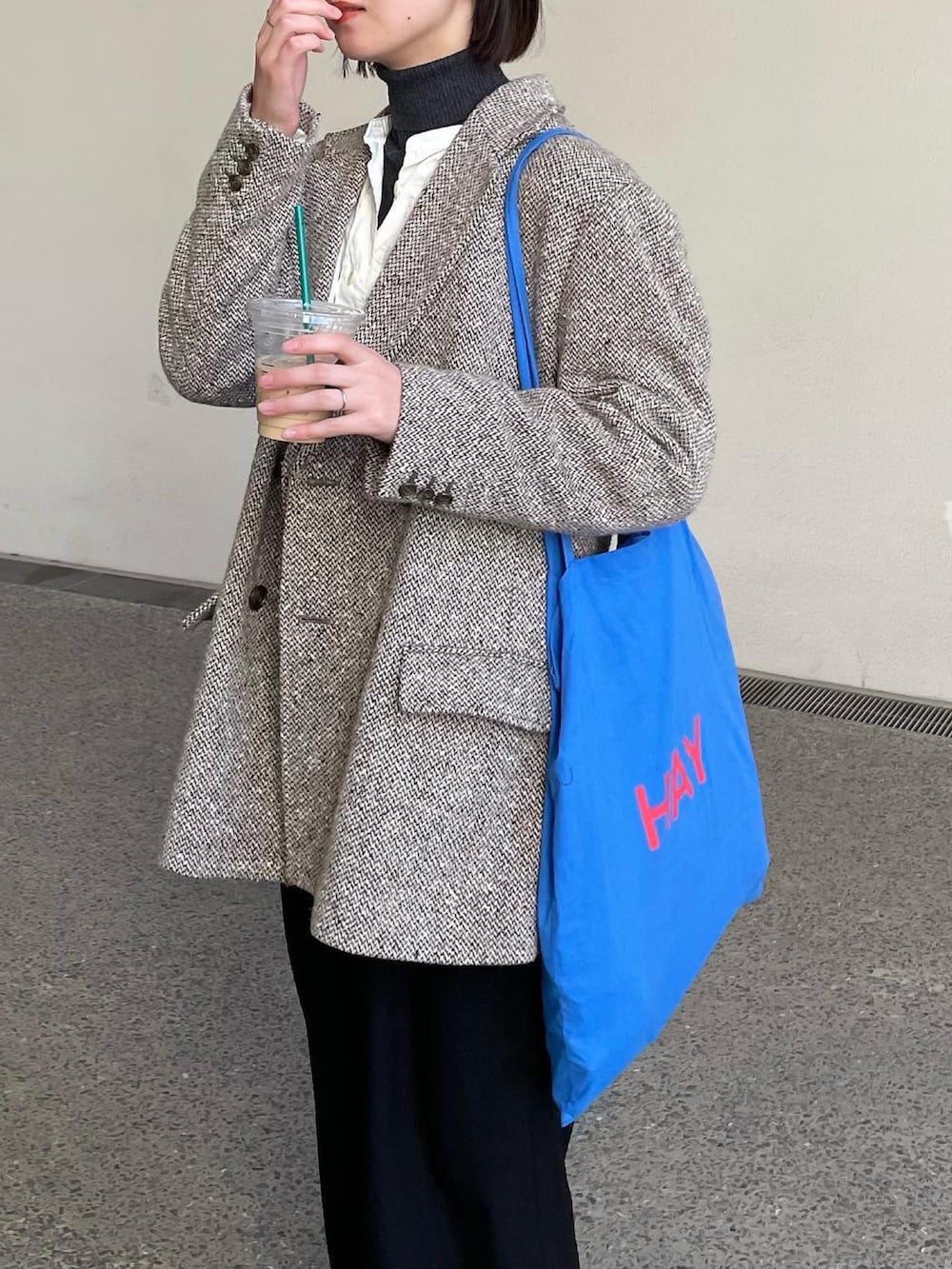 ブラック系のスカート、ホワイト系のスニーカーを着用したレディースの春コーディネートの2枚目の写真