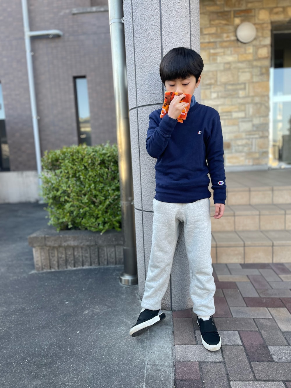 グレー系のスウェットパンツ、ブルー系のスウェット、ブラック系のスリッポンを着用したキッズの春コーディネートの2枚目の写真