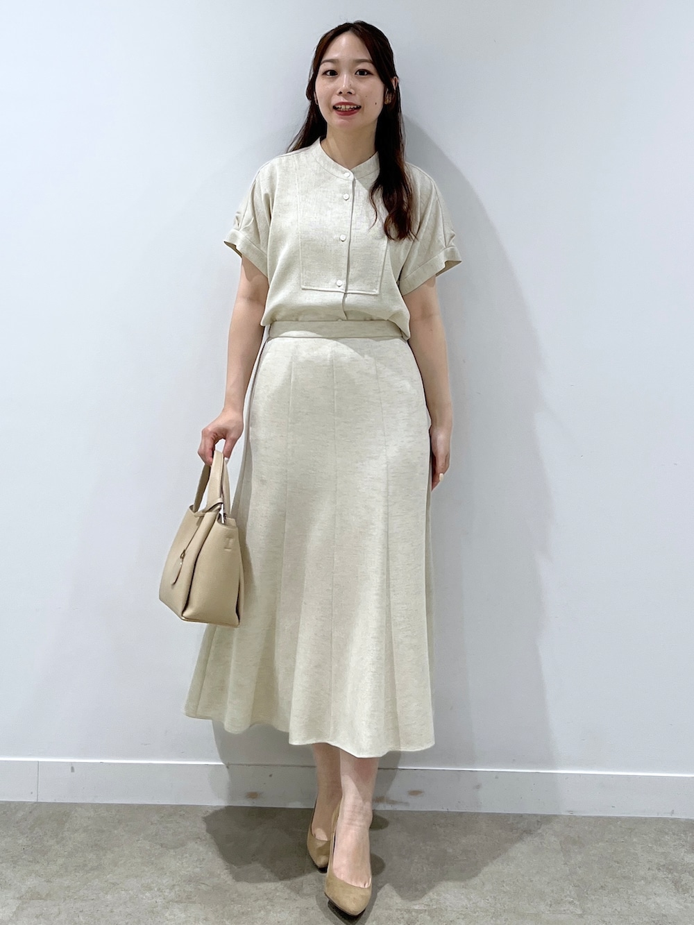 ベージュ系のシャツ/ブラウス、ベージュ系のスカート、ベージュ系のショルダーバッグを着用したレディースの春コーディネートの4枚目の写真
