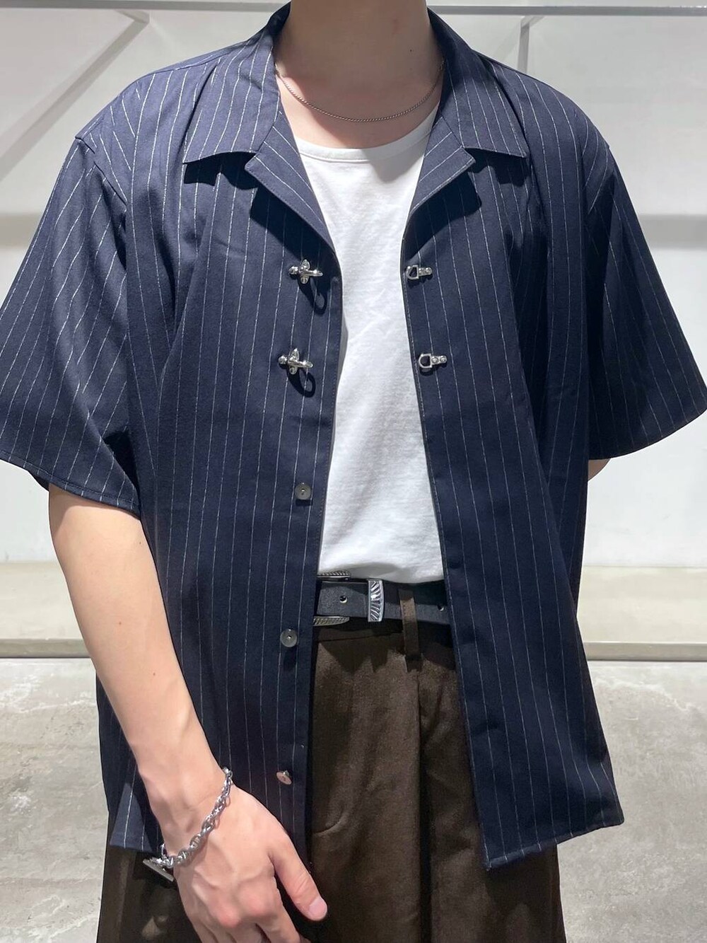 ホワイト系のTシャツ/カットソー、ブラック系のスラックス、ブルー系のシャツ/ブラウスを着用したメンズの夏コーディネートの4枚目の写真