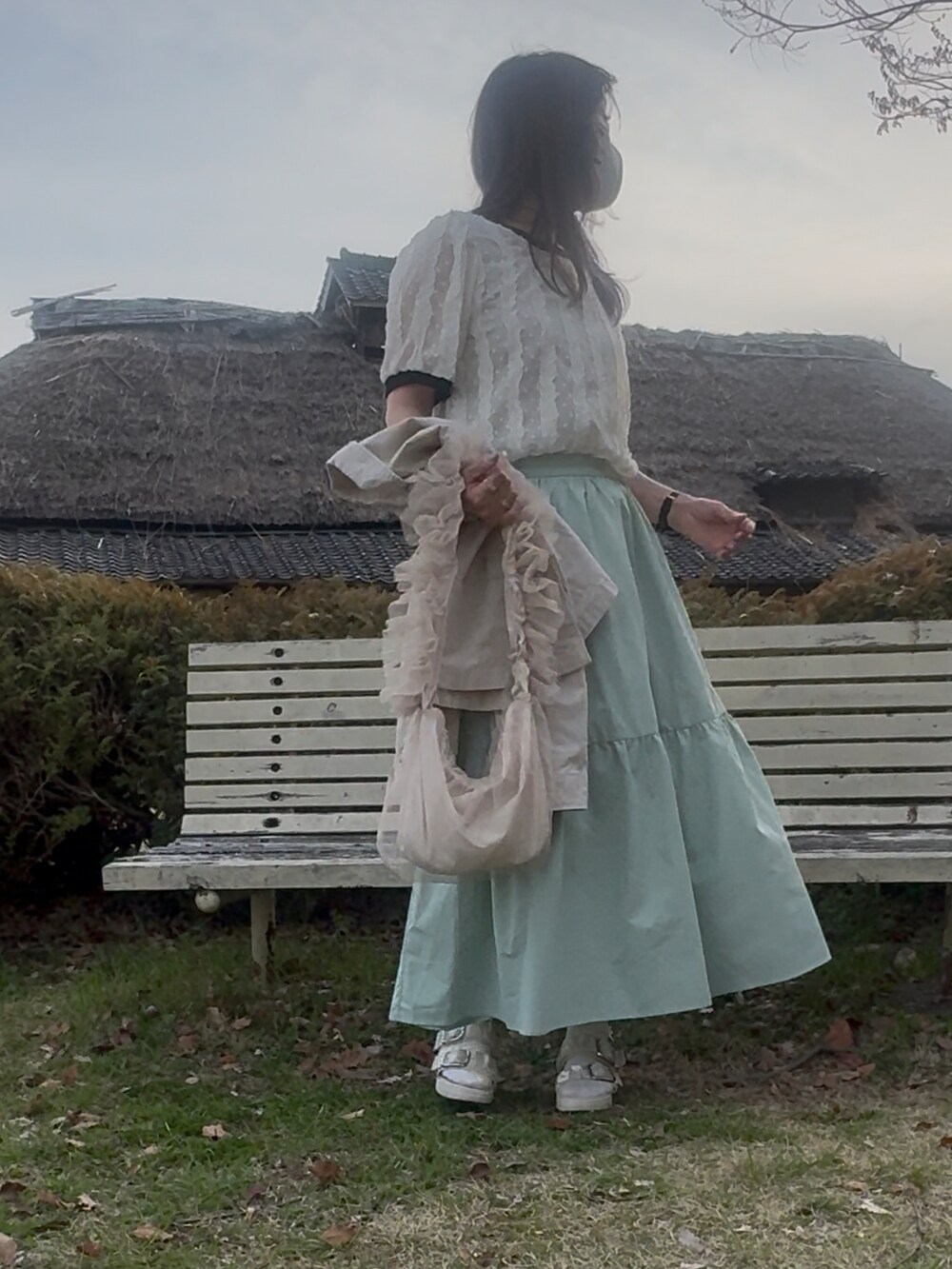 ホワイト系のシャツ/ブラウス、ホワイト系のジャケット/アウター、グリーン系のスカートを着用したレディースの春コーディネートの2枚目の写真