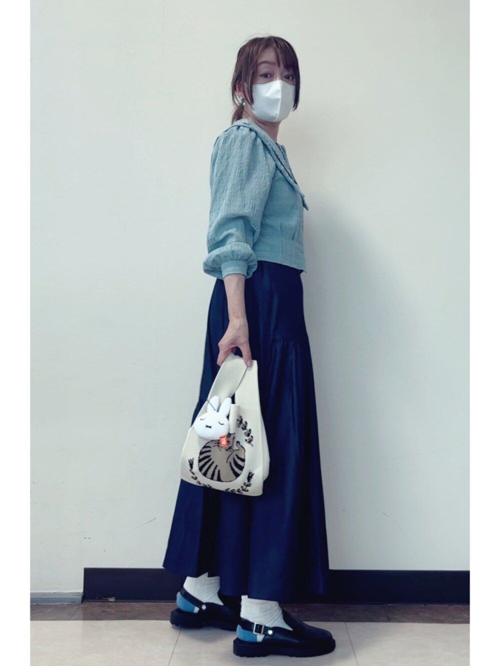 ブルー系のシャツ/ブラウス、ホワイト系のトートバッグ、ブラック系のサンダルを着用したレディースの春コーディネートの3枚目の写真