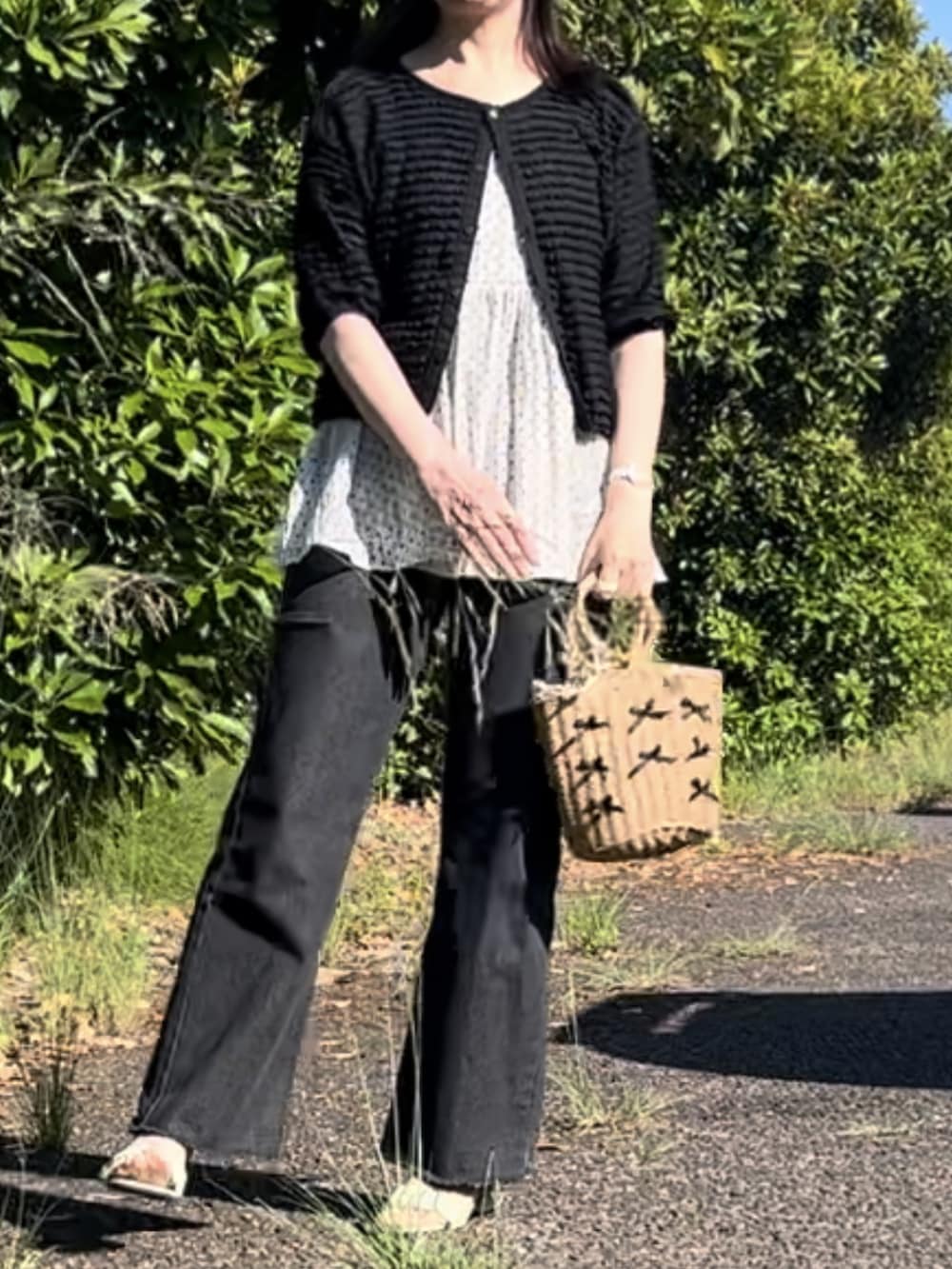 ホワイト系のキャミソール、ベージュ系のかごバッグ、グリーン系のサンダルを着用したレディースの夏コーディネートの3枚目の写真