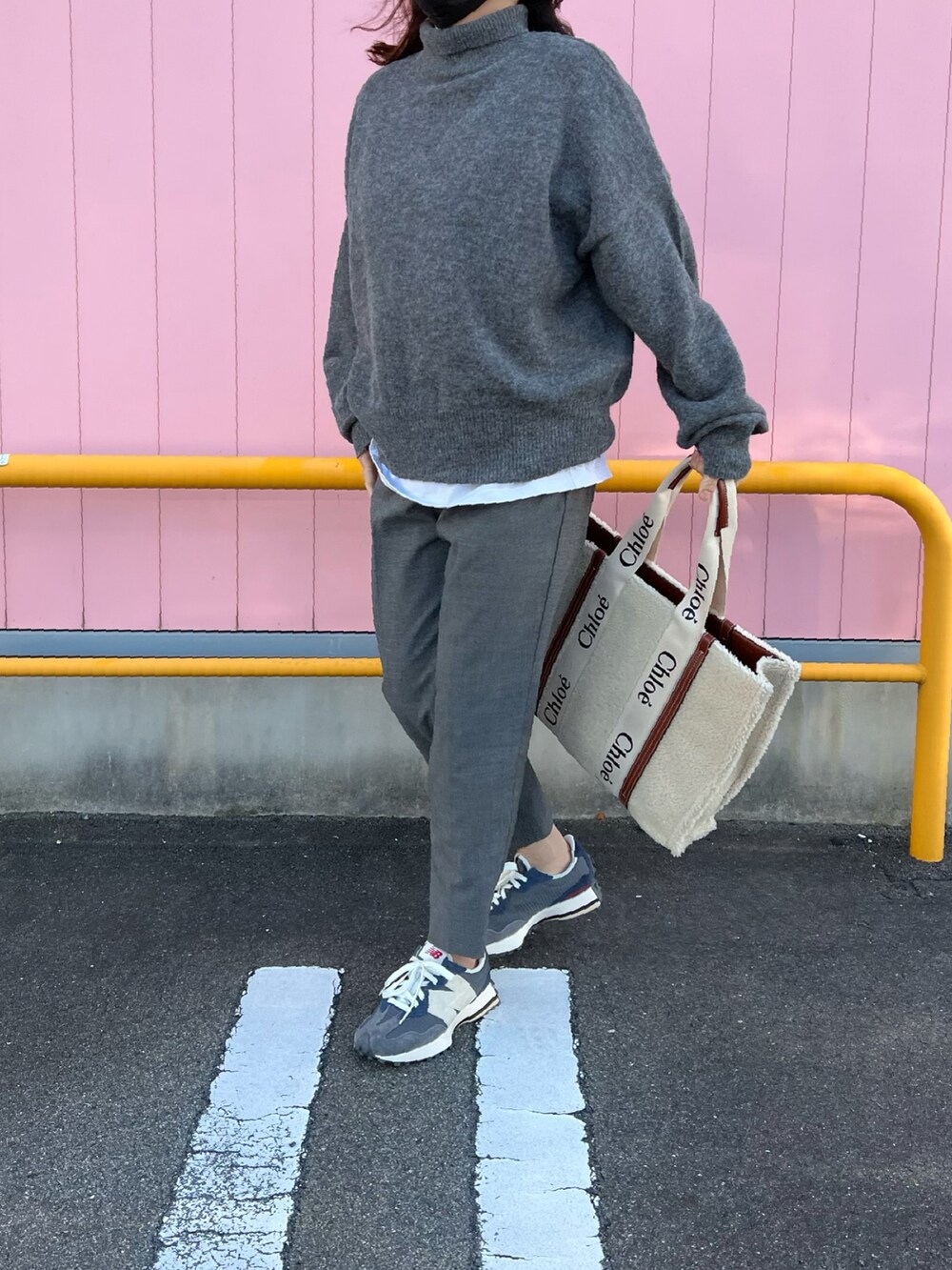 グレー系のニット/セーター、ホワイト系のTシャツ/カットソー、ベージュ系のトートバッグを着用したレディースの春コーディネートの2枚目の写真