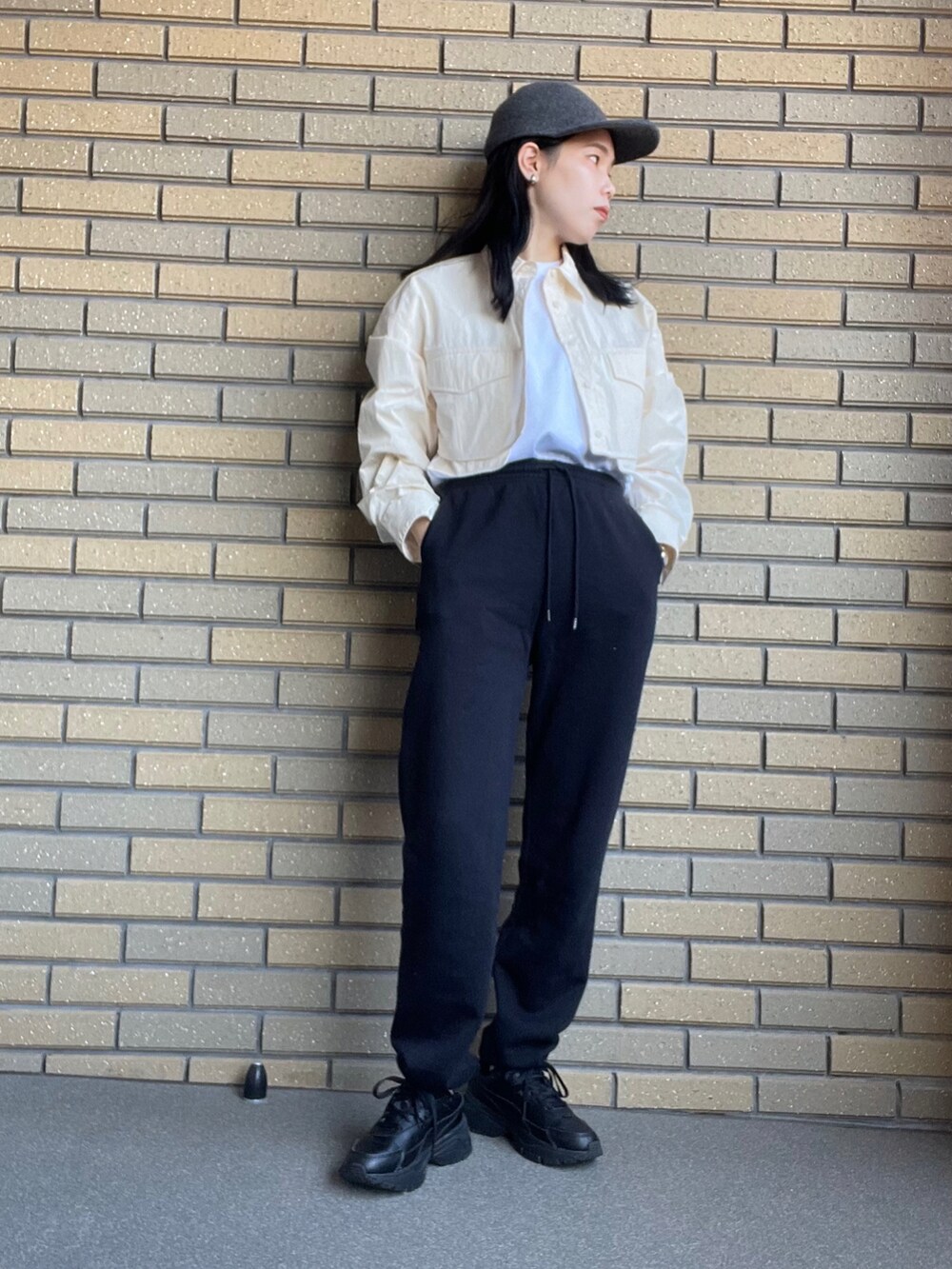 ブラック系のスウェットパンツ、ホワイト系のシャツ/ブラウス、ブラック系のスニーカーを着用したレディースの秋コーディネートの2枚目の写真