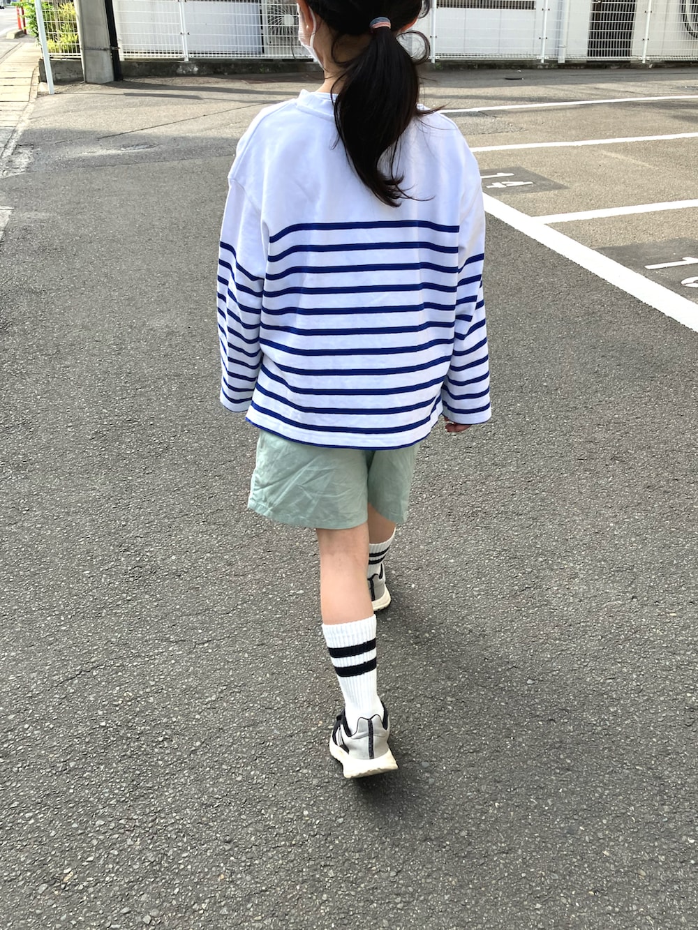 ブルー系のTシャツ/カットソー、グリーン系のその他パンツ、ブラック系のスニーカーを着用したキッズの春コーディネートの2枚目の写真