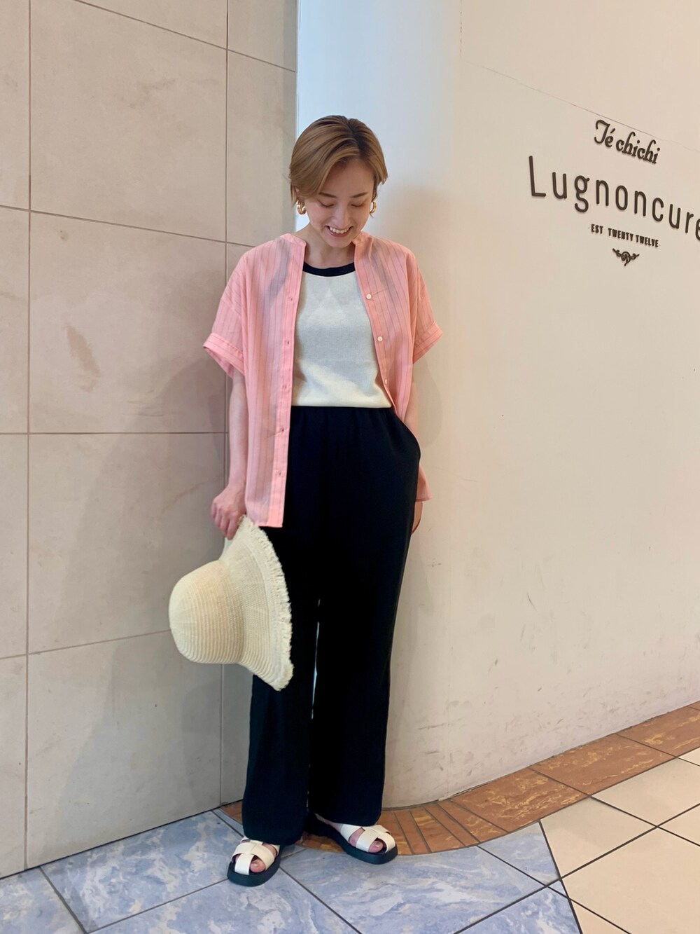 ピンク系のシャツ/ブラウス、ブラック系のその他パンツ、ホワイト系のサンダルを着用したレディースの夏コーディネートの2枚目の写真