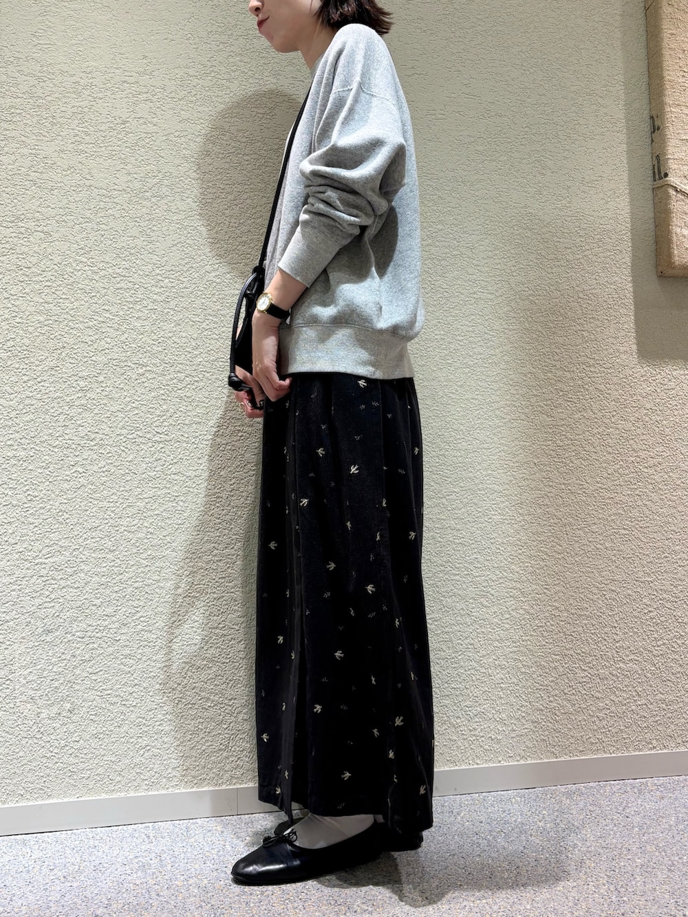 ブラック系のスカート、ブラック系のショルダーバッグ、シルバー系のネックレスを着用したレディースの冬コーディネートの6枚目の写真