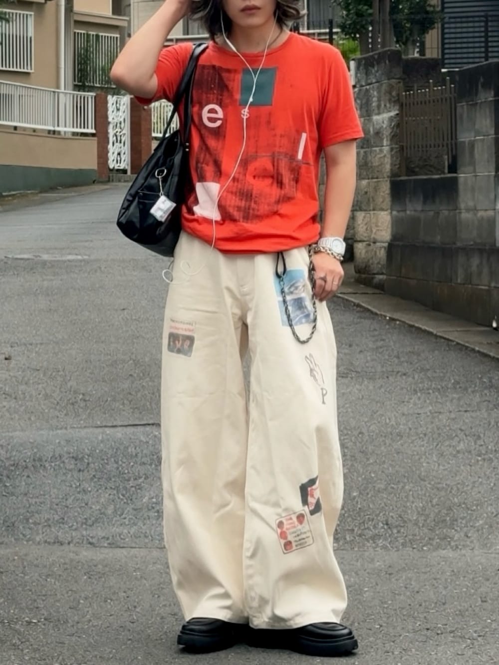 ホワイト系のその他パンツ、オレンジ系のTシャツ/カットソー、ブラック系のシューズを着用したメンズの夏コーディネートの2枚目の写真