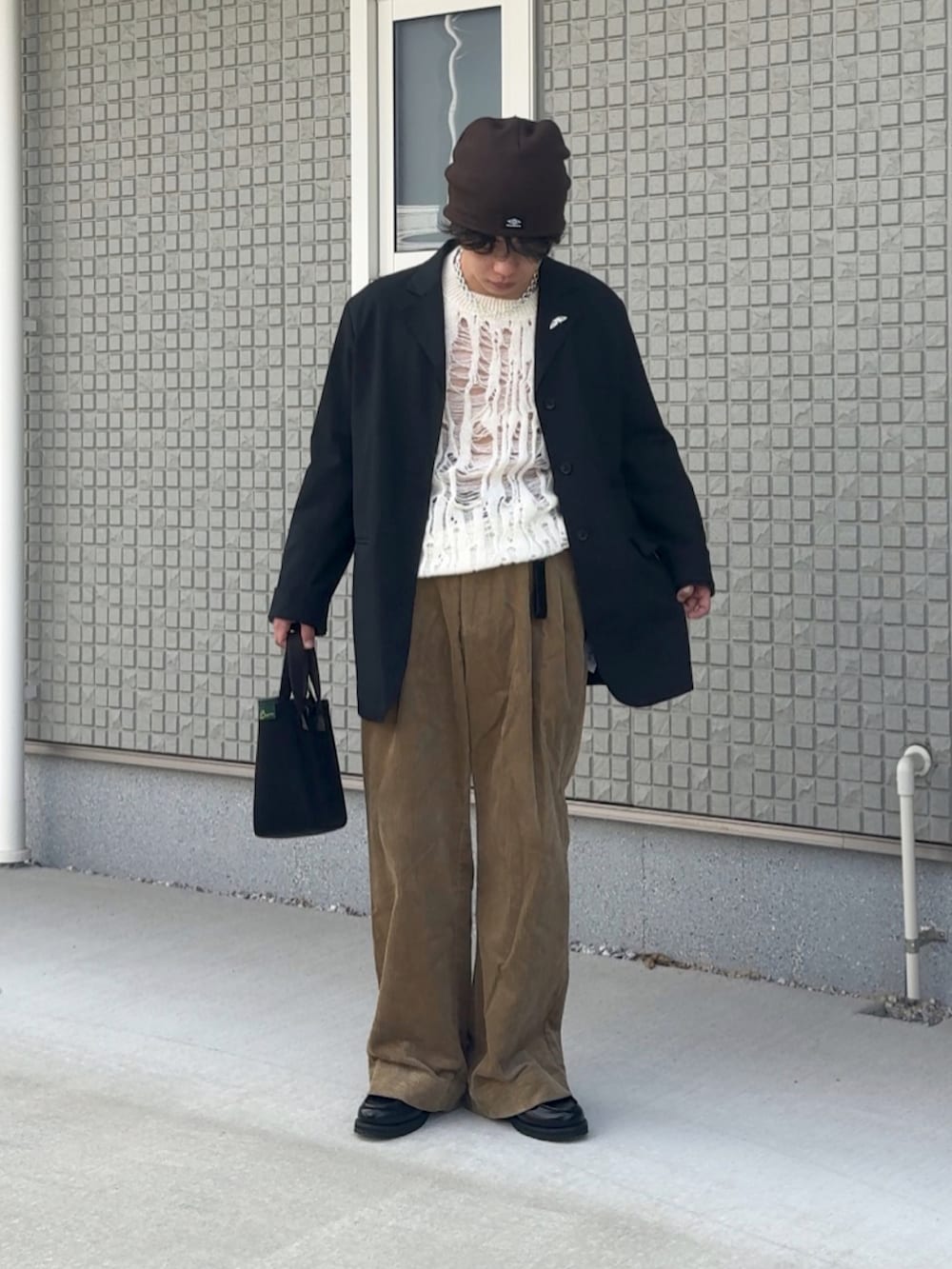 ブラック系のテーラードジャケット、ブラック系のローファー、ベージュ系のその他パンツを着用したメンズの秋コーディネートの2枚目の写真