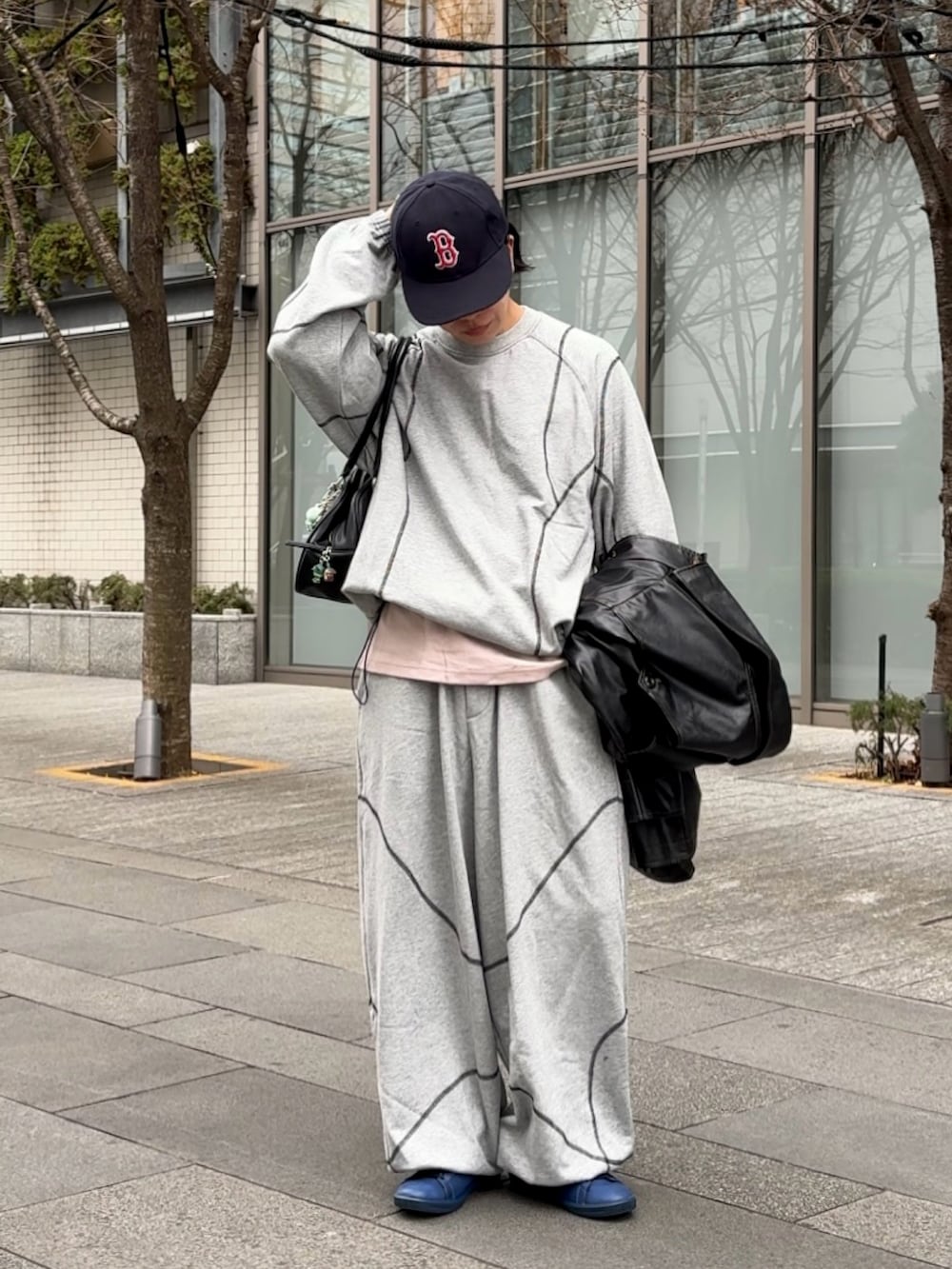 グレー系のスウェットパンツ、グレー系のスウェット、ブラック系のショルダーバッグを着用したメンズの冬コーディネートの2枚目の写真