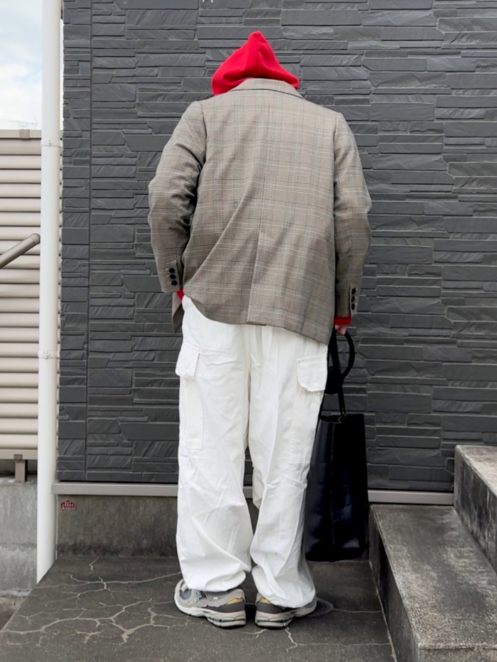 ホワイト系のカーゴパンツ、グレー系のスニーカー、レッド系のパーカーを着用したメンズの冬コーディネートの3枚目の写真