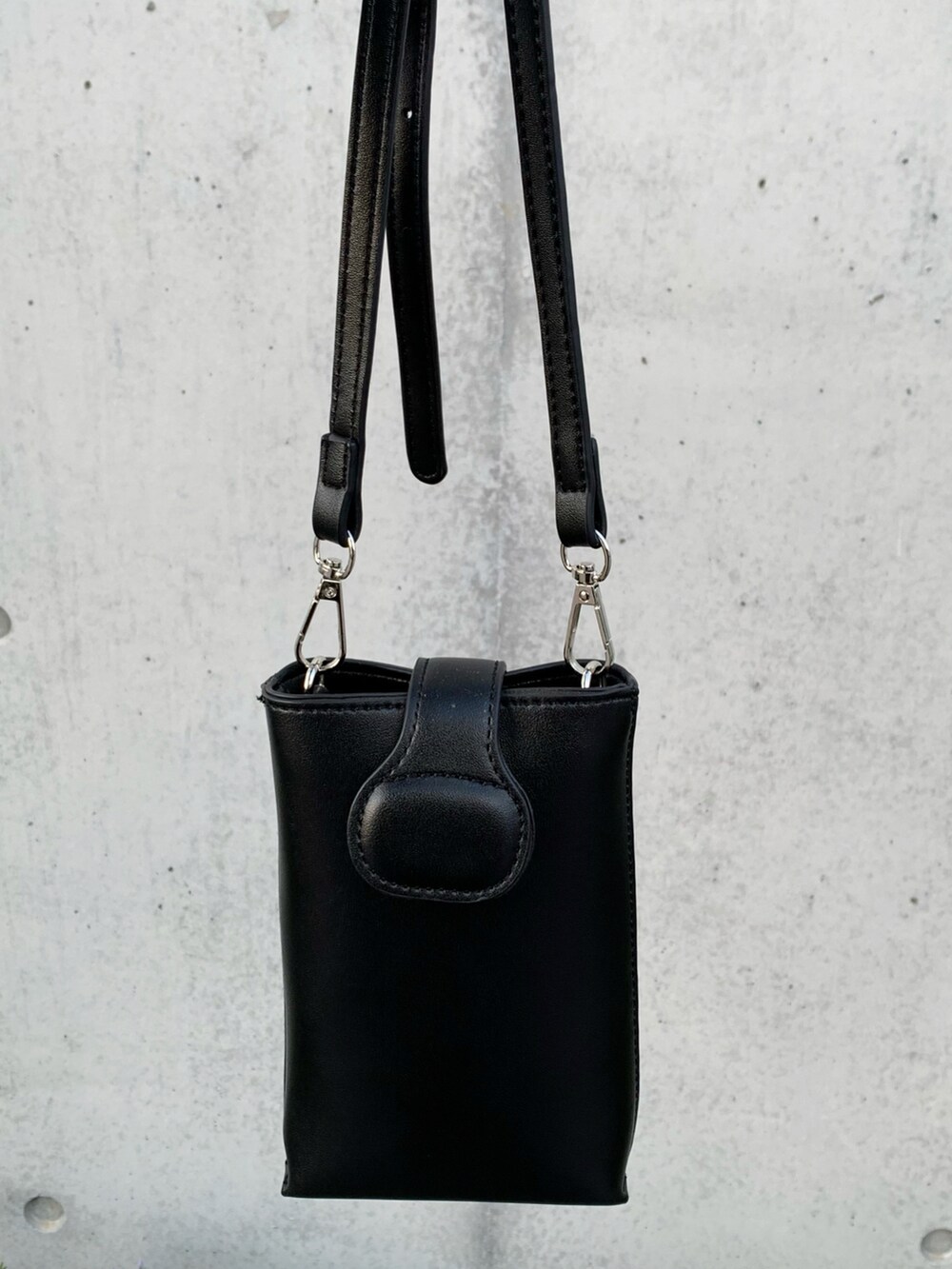 ブルー系のデニムジャケット、ブラック系のショルダーバッグ、ブラウン系のその他パンツを着用したメンズの冬コーディネートの2枚目の写真