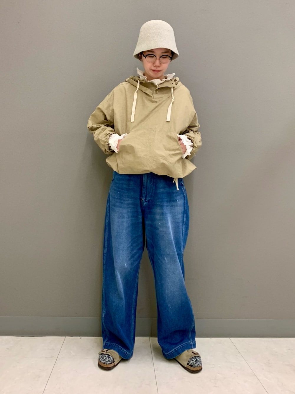 ブルー系のデニムパンツ、ベージュ系のTシャツ/カットソー、ホワイト系のシャツ/ブラウスを着用したレディースの秋コーディネートの4枚目の写真