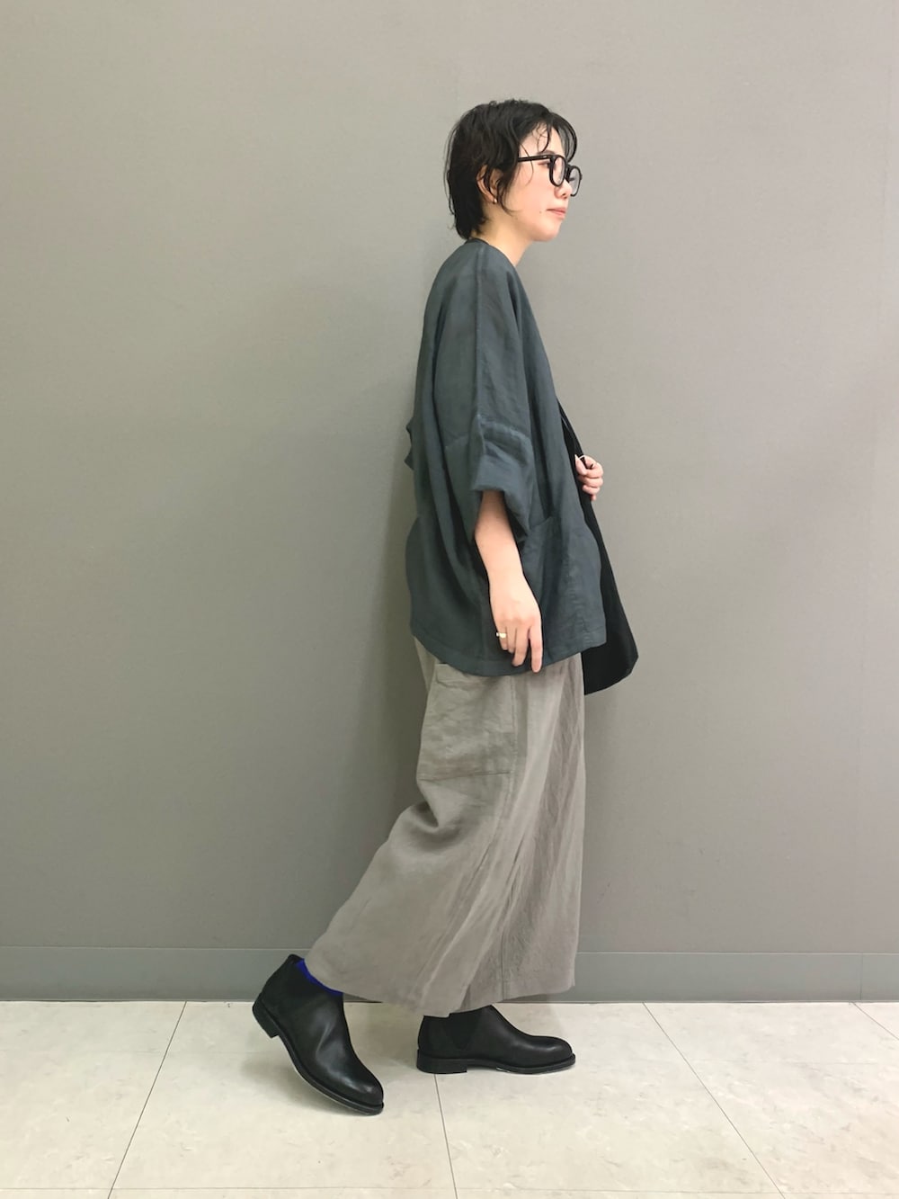 ホワイト系のTシャツ/カットソー、ブラック系のブーツ、ブルー系のノーカラージャケットを着用したレディースの春コーディネートの3枚目の写真