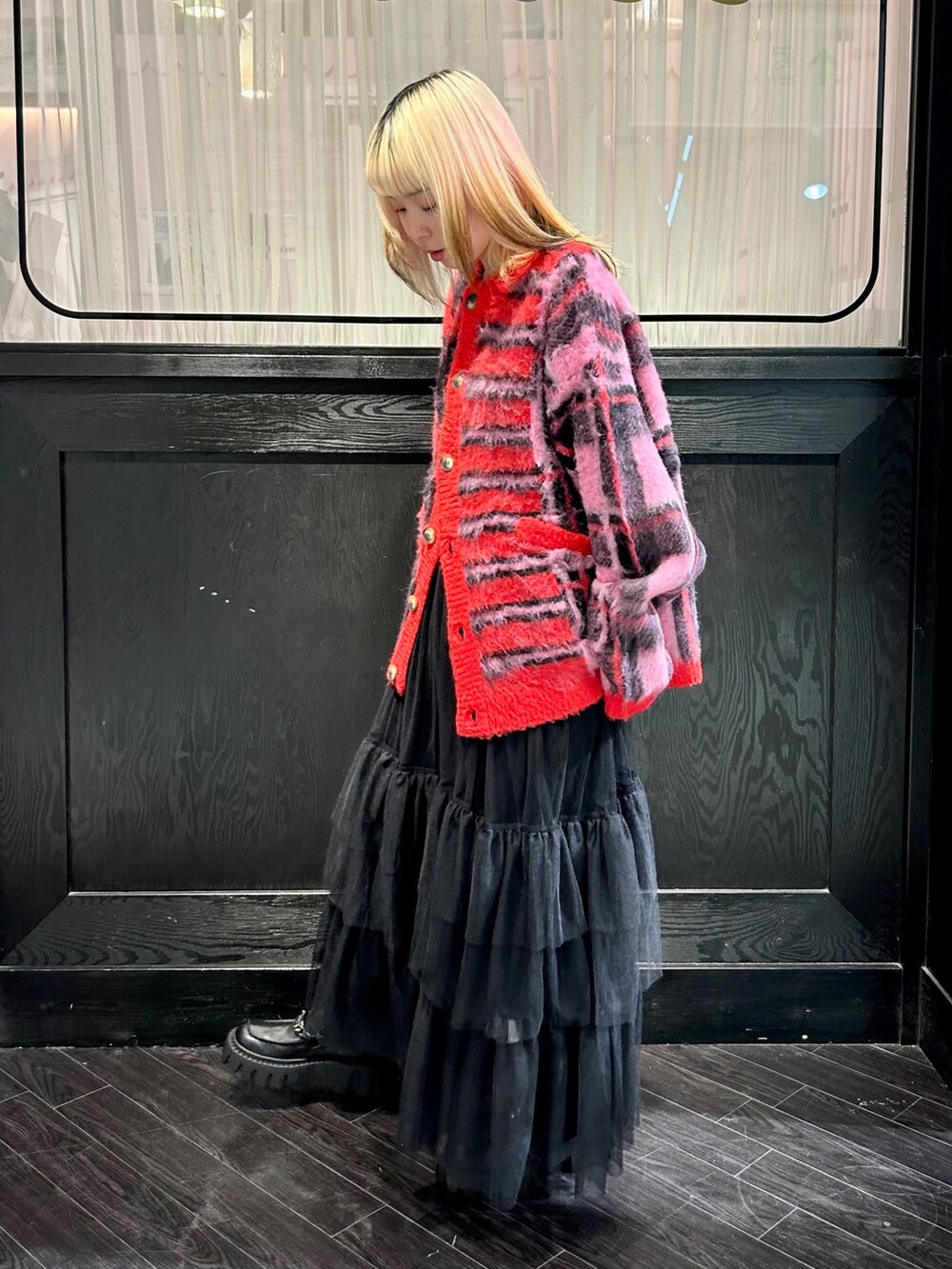 レッド系のカーディガン/ボレロ、ブラック系のワンピース、ブラック系のその他パンツを着用したレディースの冬コーディネートの4枚目の写真