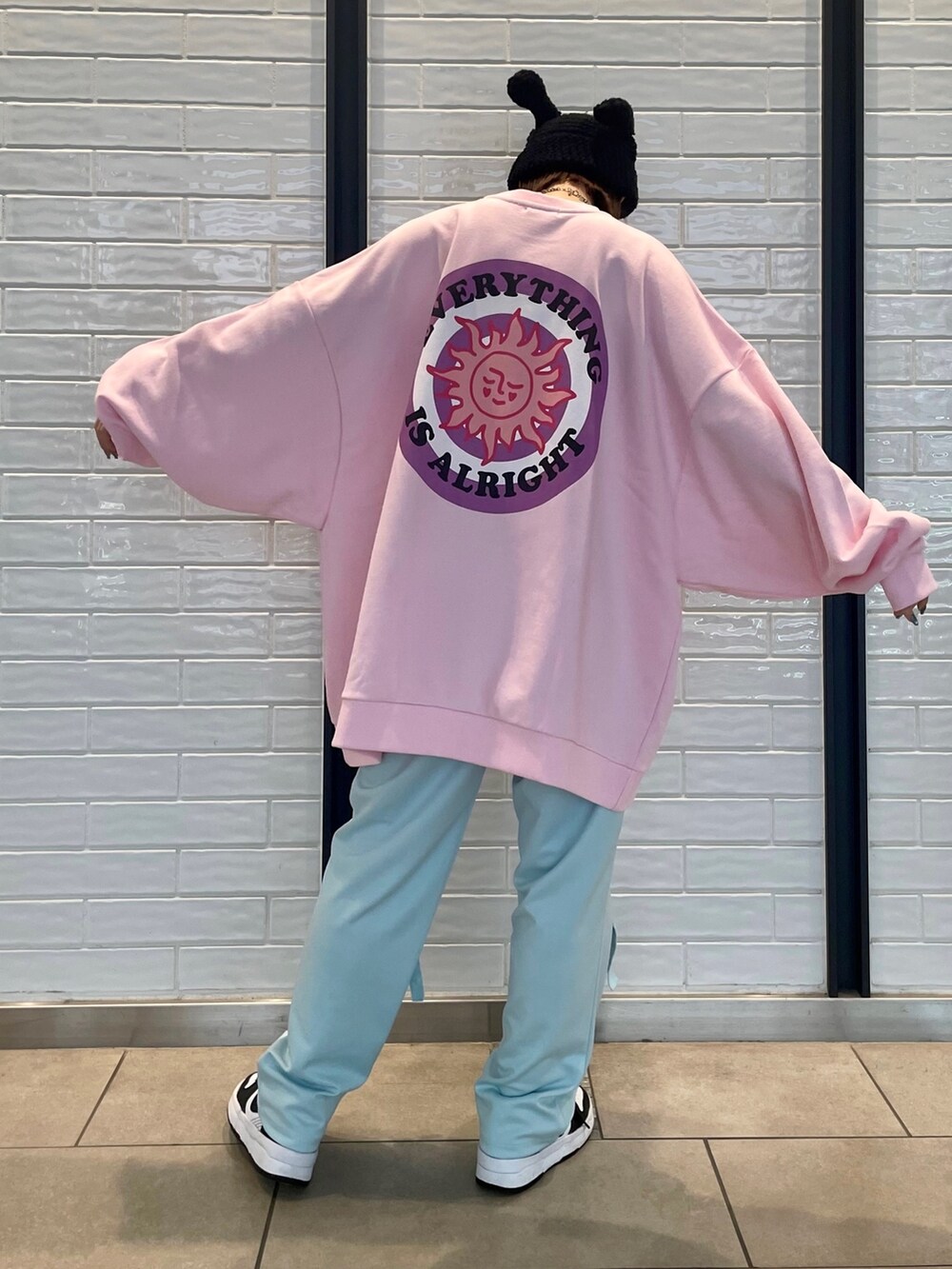 ピンク系のスウェット、ブルー系のその他パンツを着用したレディースの冬コーディネートの3枚目の写真