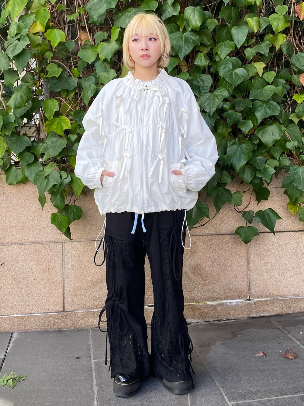 ホワイト系のブルゾン、グレー系のTシャツ/カットソー、ブラック系のその他パンツを着用したレディースの冬コーディネートの4枚目の写真