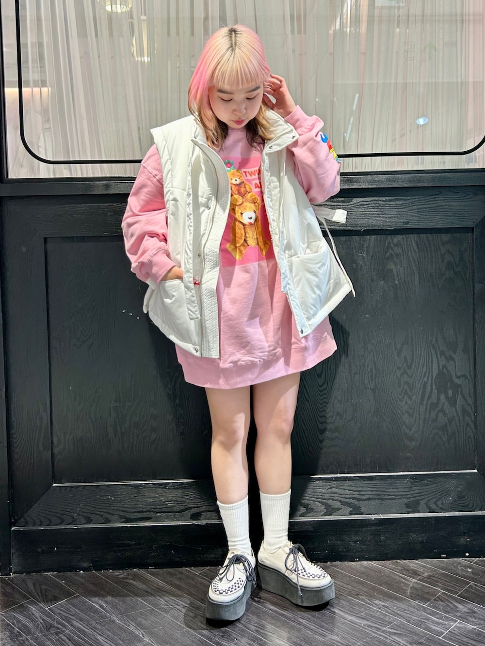 ピンク系のスウェット、ホワイト系のダウンベストを着用したレディースの秋コーディネートの3枚目の写真