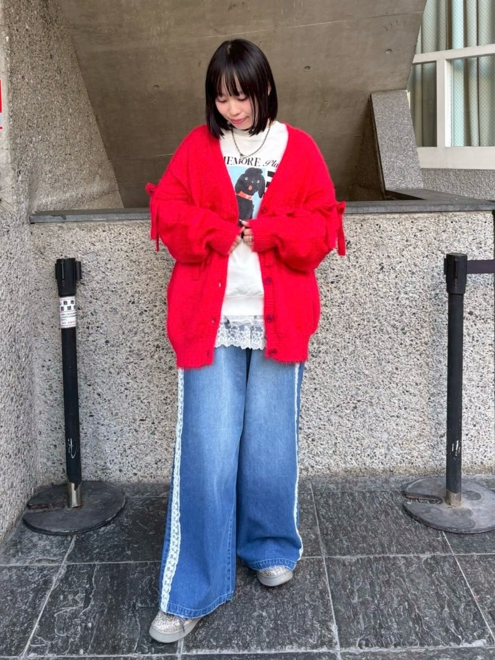 ブルー系のデニムパンツ、ホワイト系のスウェット、レッド系のカーディガン/ボレロを着用したレディースの冬コーディネートの3枚目の写真