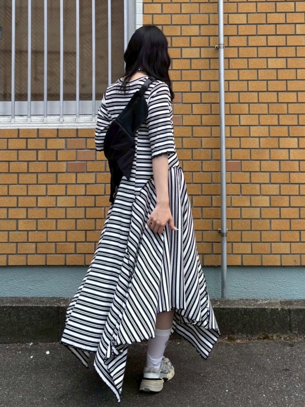 ブラック系のワンピース、ブラック系のボディバッグ/ウエストポーチ、ホワイト系のバレッタ/ヘアクリップを着用したレディースの夏コーディネートの6枚目の写真