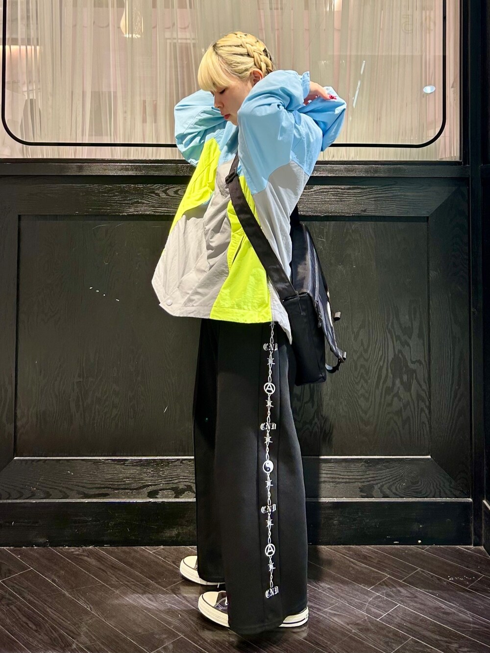 ブルー系のナイロンジャケット、ブラック系のその他パンツ、ブラック系のショルダーバッグを着用したレディースの夏コーディネートの2枚目の写真