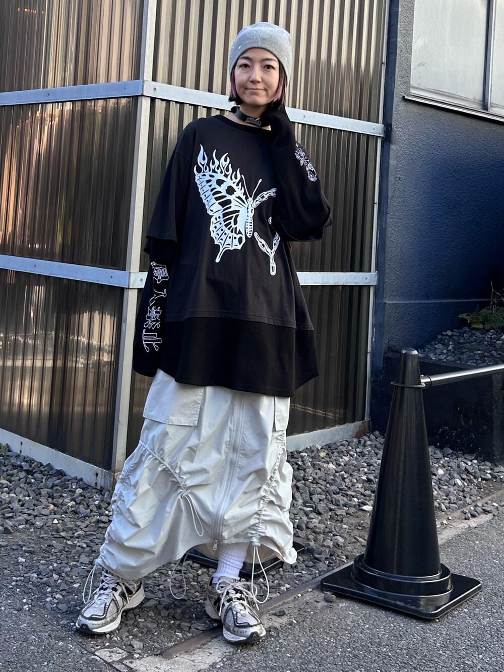 ブラック系のTシャツ/カットソー、ホワイト系のスカート、シルバー系のシューズを着用したレディースの春コーディネートの2枚目の写真