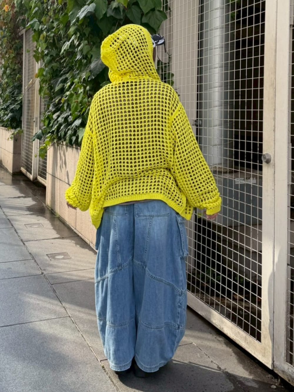 イエロー系のパーカー、ブラウン系のTシャツ/カットソー、ブルー系のデニムパンツを着用したレディースの春コーディネートの3枚目の写真