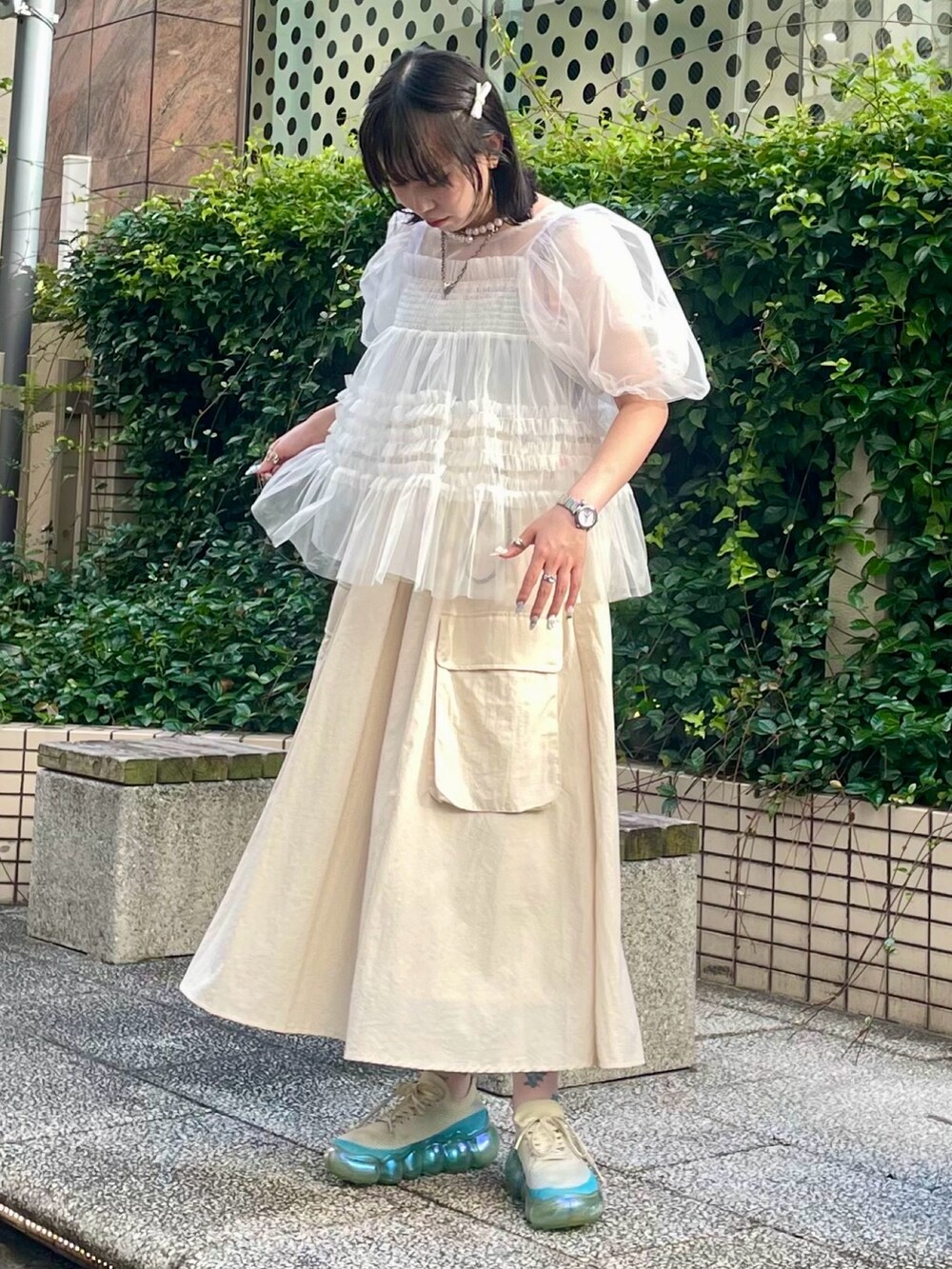 ホワイト系のジャンパースカート、ブルー系のキャミソール、ホワイト系のシャツ/ブラウスを着用したレディースの夏コーディネートの2枚目の写真