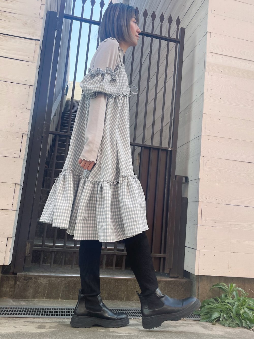 グレー系のワンピース、ブラック系のブーツを着用したレディースの冬コーディネートの3枚目の写真