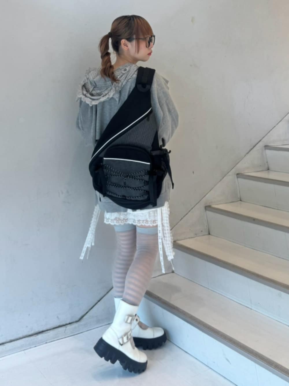 ホワイト系のその他パンツ、グレー系のパーカー、ブラック系のショルダーバッグを着用したレディースの秋コーディネートの3枚目の写真
