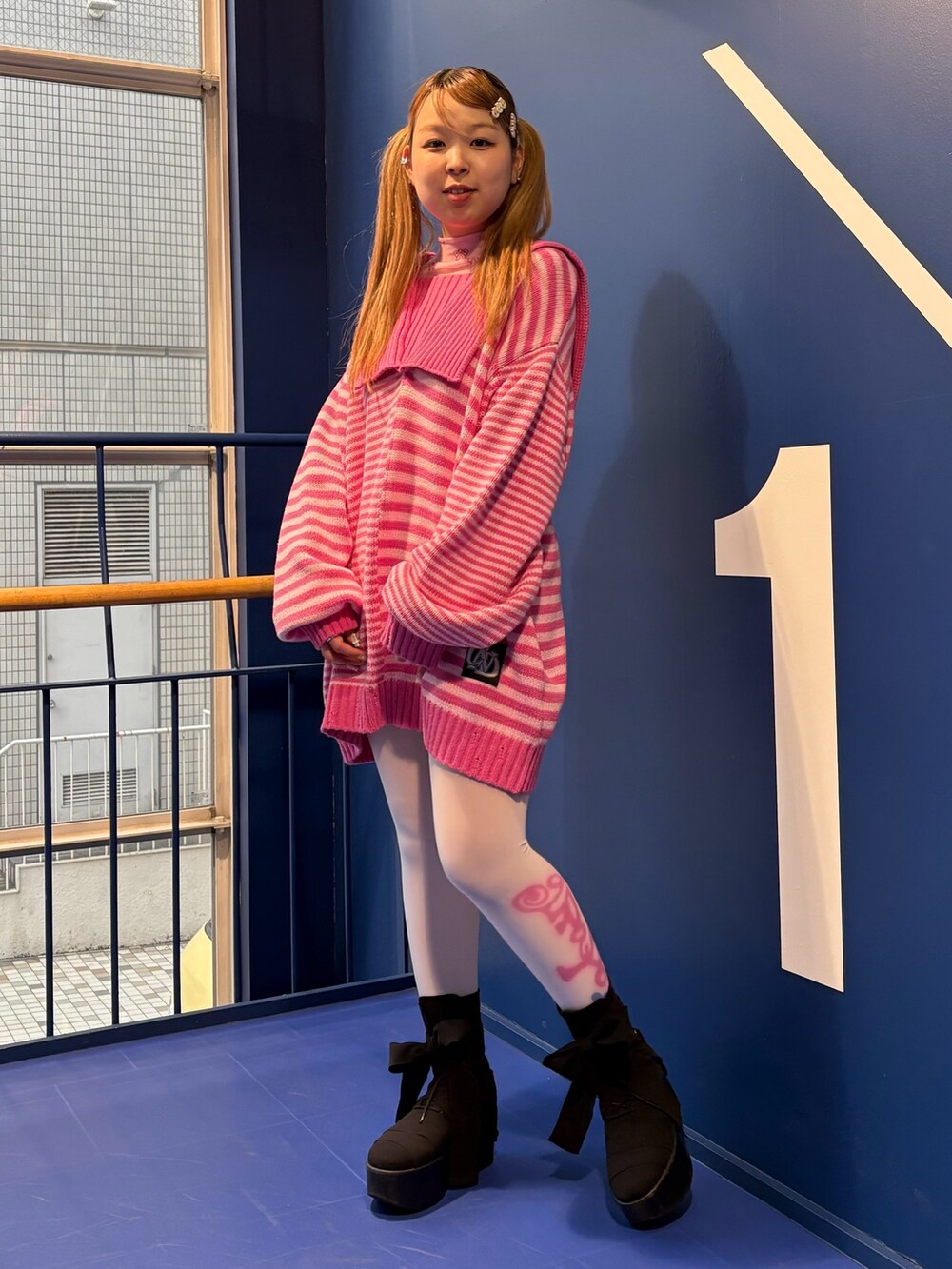 ピンク系のニット/セーター、ピンク系のその他トップスを着用したレディースの冬コーディネートの3枚目の写真