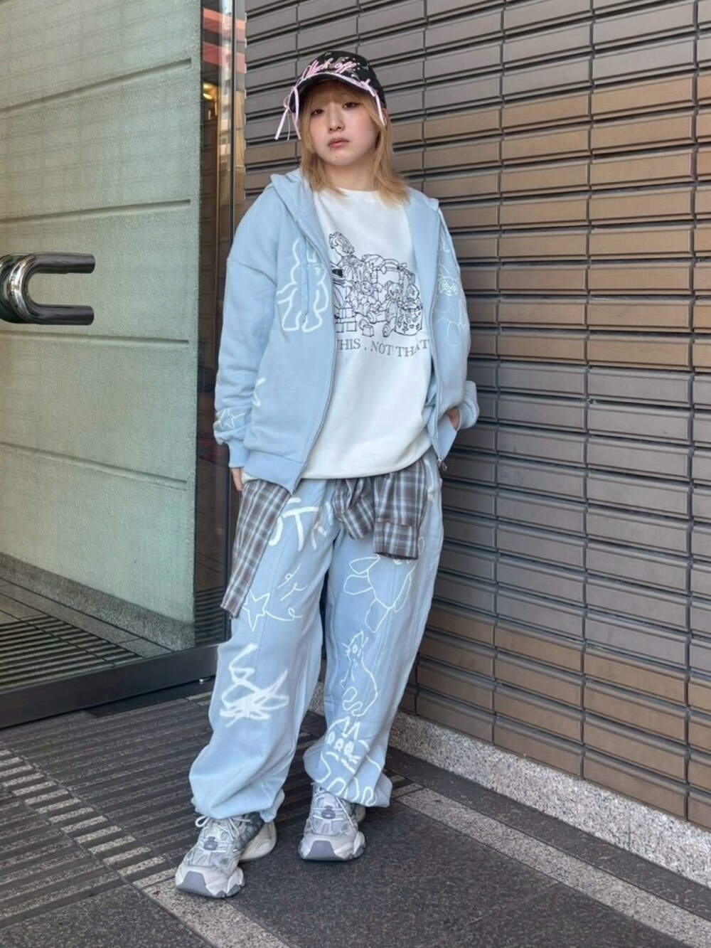 ブルー系のスウェットパンツ、ブラウン系のシャツ/ブラウス、ホワイト系のスウェットを着用したレディースの冬コーディネートの3枚目の写真