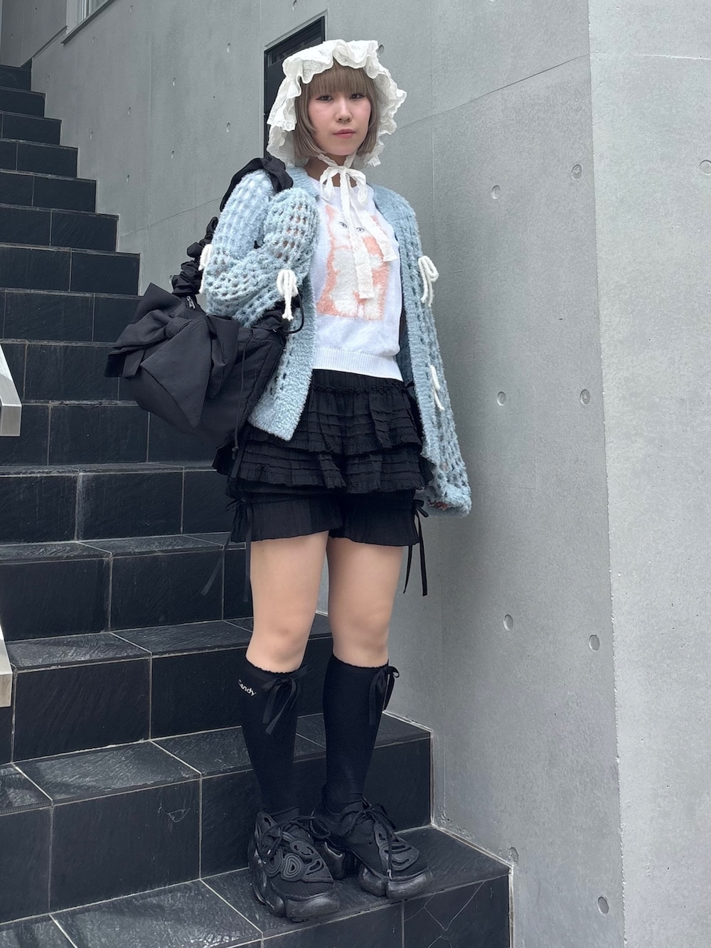 ブルー系のカーディガン/ボレロ、ホワイト系のニット/セーター、ブラック系のその他パンツを着用したレディースの夏コーディネートの3枚目の写真