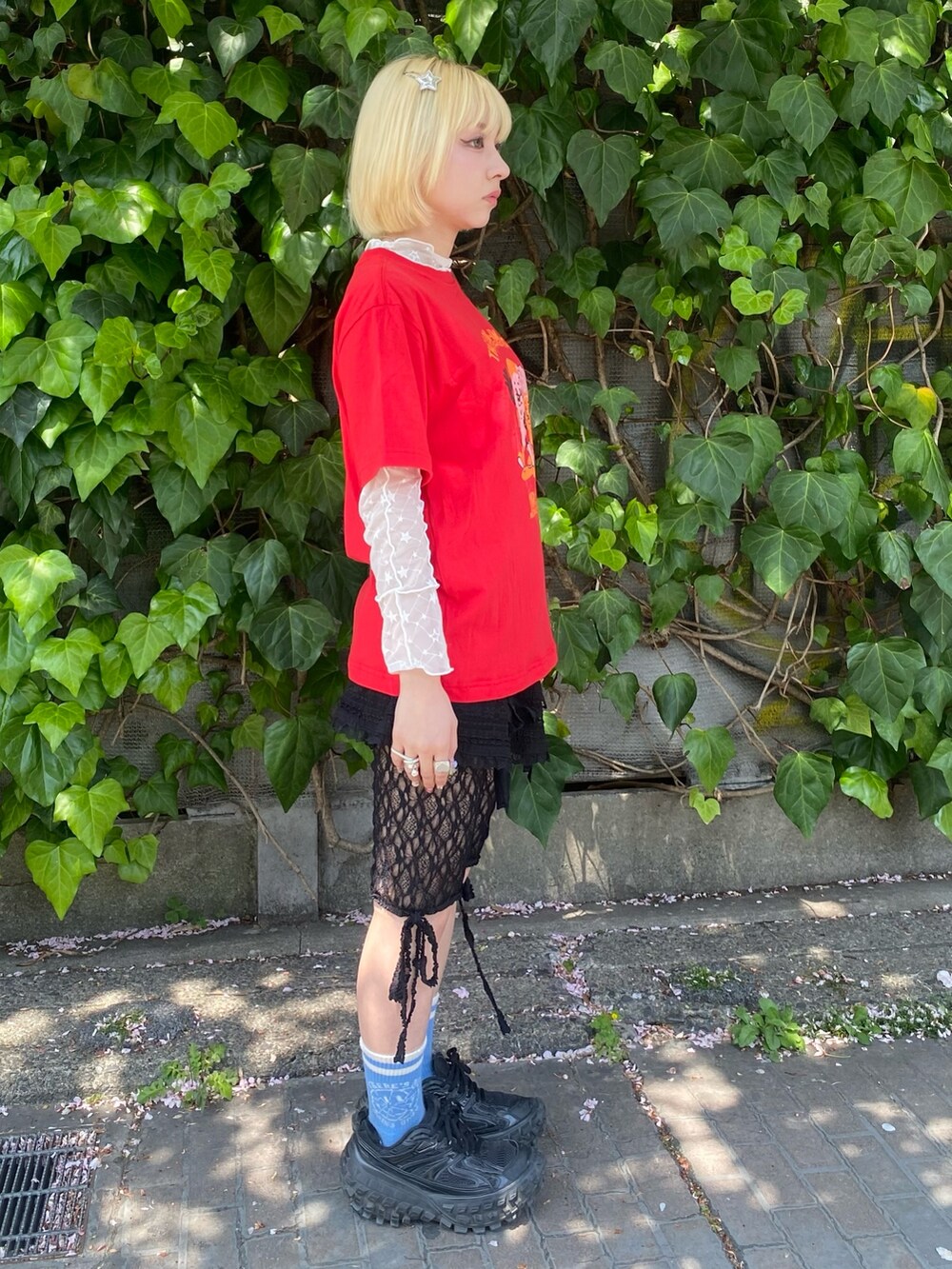 レッド系のTシャツ/カットソー、ホワイト系のその他トップス、ブラック系のスカートを着用したレディースの春コーディネートの5枚目の写真