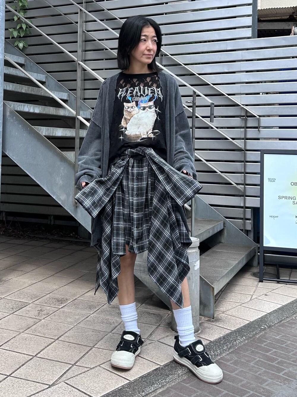 ブラック系のスカート、ブラック系のTシャツ/カットソー、グレー系のカーディガン/ボレロを着用したレディースの秋コーディネートの4枚目の写真