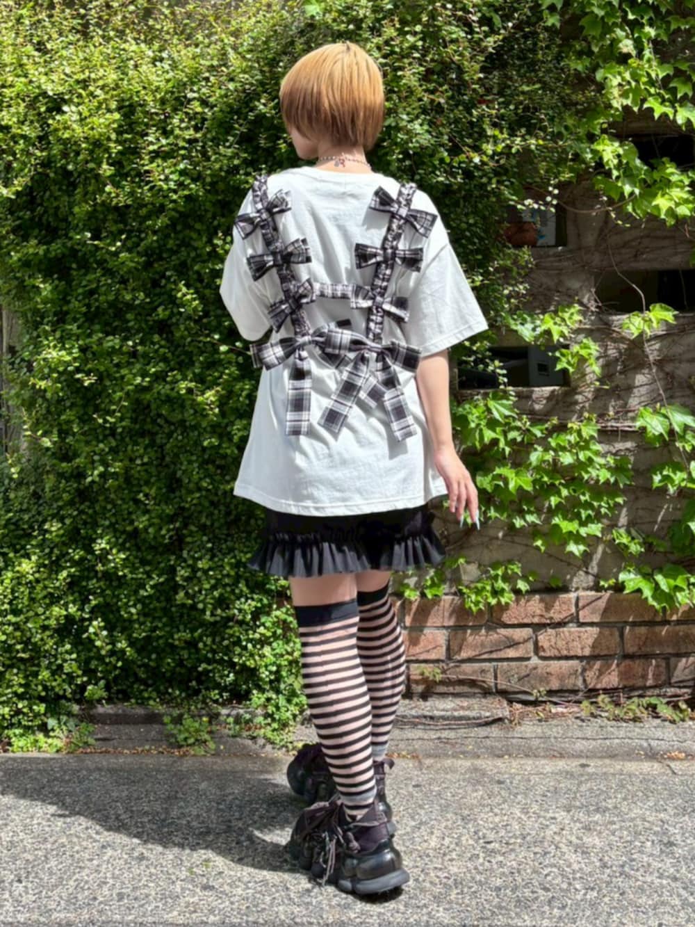 ブラック系のその他トップス、ブラック系のその他パンツ、ホワイト系のTシャツ/カットソーを着用したレディースの春コーディネートの3枚目の写真