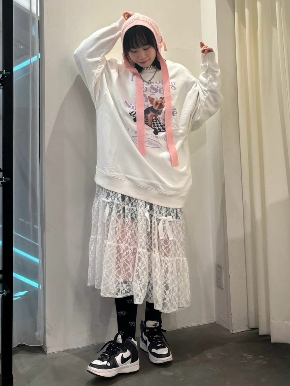 ホワイト系のシューズ、ホワイト系のスウェット、ピンク系のワンピースを着用したレディースの秋コーディネートの3枚目の写真