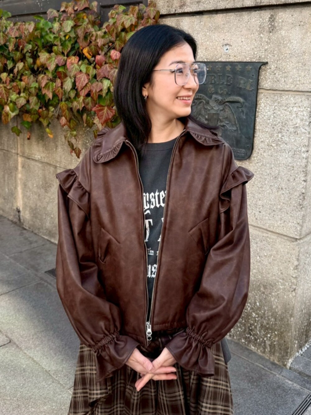 グレー系のTシャツ/カットソー、ブラウン系のライダースジャケット、ブラウン系のその他パンツを着用したレディースの冬コーディネートの4枚目の写真