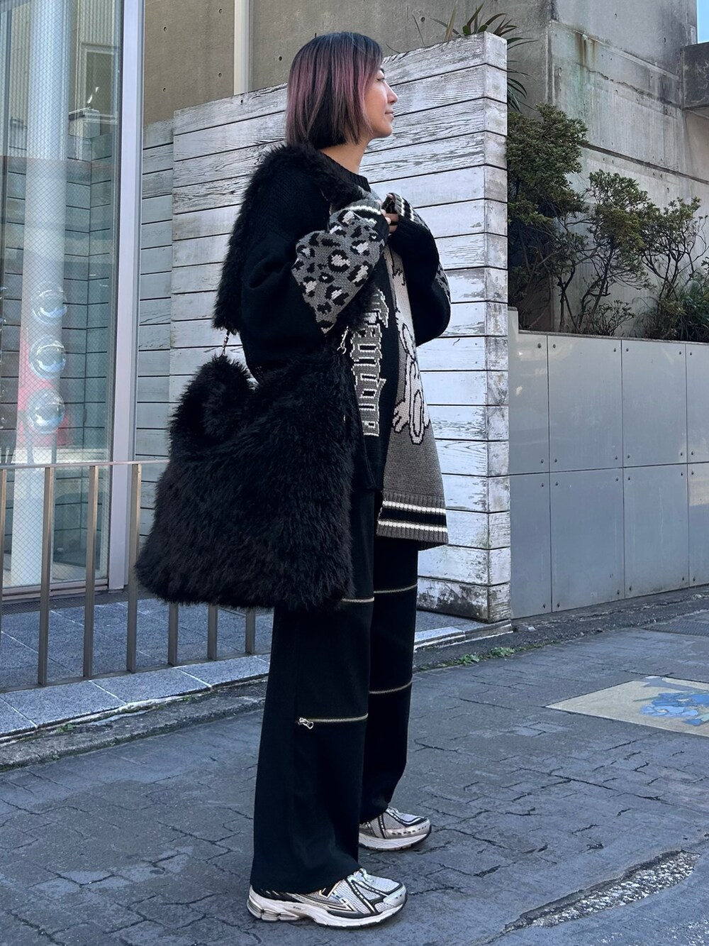 ブラック系のニット/セーター、ブラック系のその他パンツ、ブラック系のショルダーバッグを着用したレディースの秋コーディネートの3枚目の写真