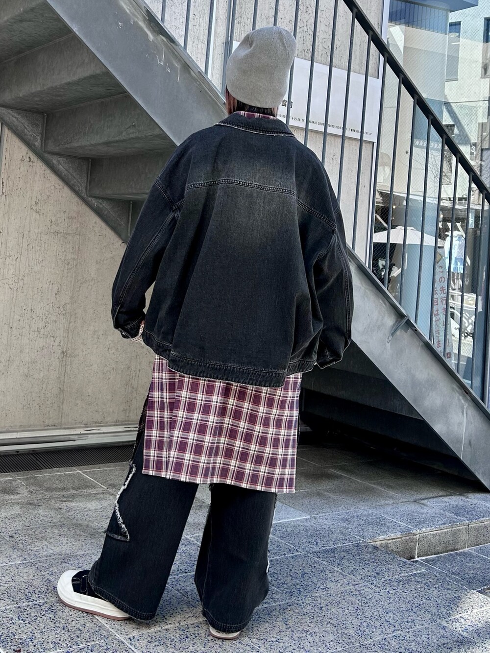 ブラック系のデニムジャケット、パープル系のシャツワンピース、ブラック系のデニムパンツを着用したレディースの春コーディネートの6枚目の写真