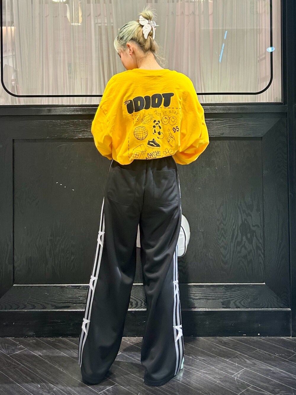 ブラック系のその他パンツ、イエロー系のTシャツ/カットソー、ホワイト系のボストンバッグを着用したレディースの冬コーディネートの4枚目の写真